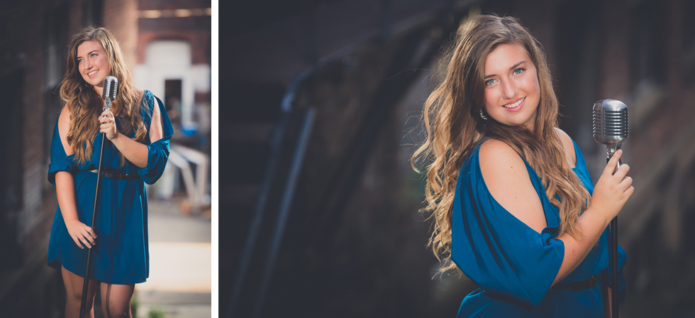 senior portrait photography of young woman with microphone in industrial, edgy looking area of Jamestown, NY, a city in WNY