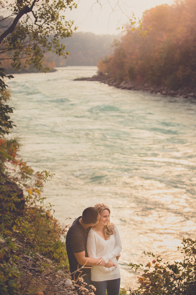 Bride and groom snuggle along path next to Niagara River in Whirlpool / Devil