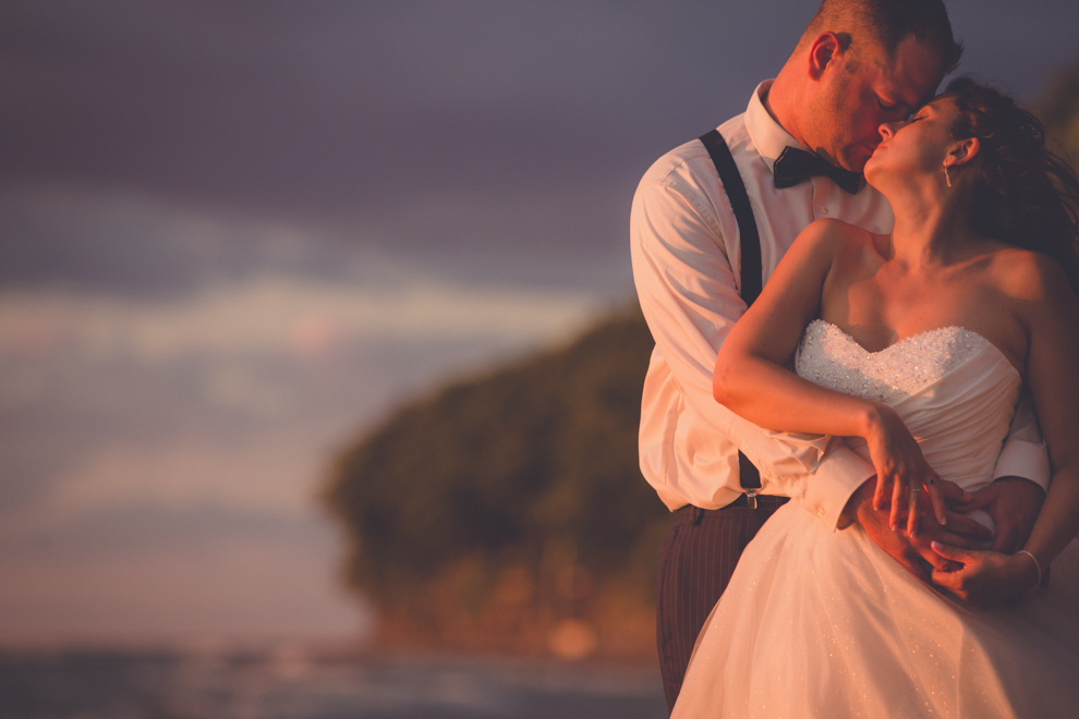 wedding photography of bride and groom embracing on beach at camp pioneer on Lake Erie near Buffalo at sunset