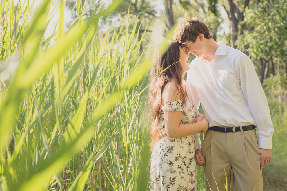 couple laughing among tall reeds at Tifft Nature Preserve in Buffalo, NY