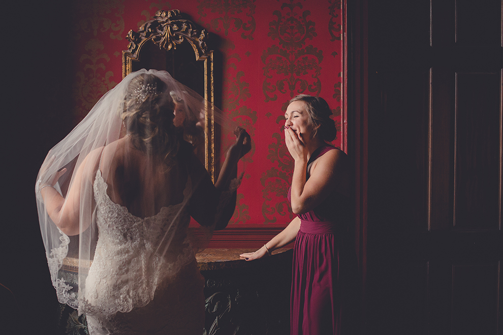 Maid of honor is brought to tears after seeing bride in veil for first time in the Georgian Ballroom at Statler City in Buffalo, NY