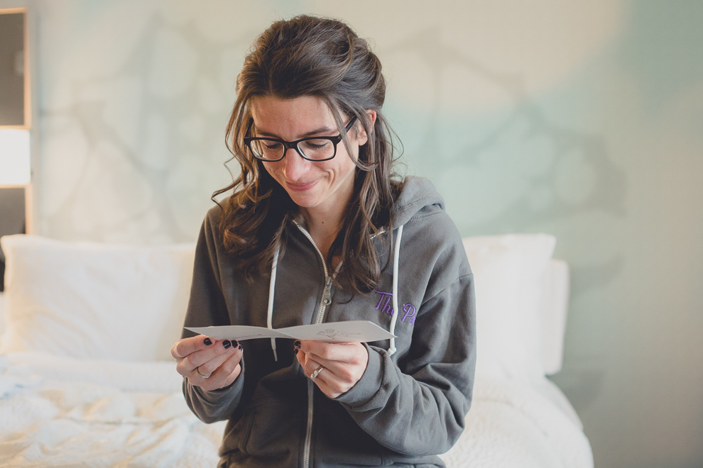 bride reads card from groom before wedding at Marriott Hotel in Buffalo, NY