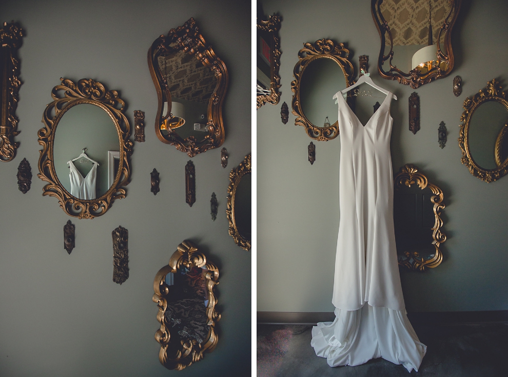 wedding dress hangs among small mirrors at Salon Elizabeth in Buffalo, NY