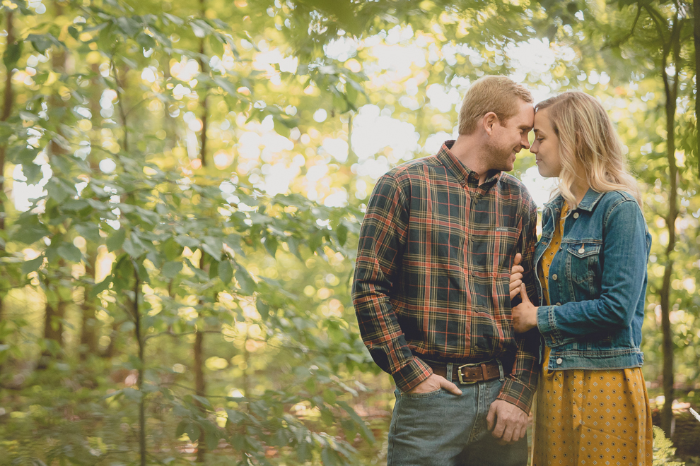 bride and groom pose for wedding engagement photos among fall foliage at their property in Ellicottville, NY