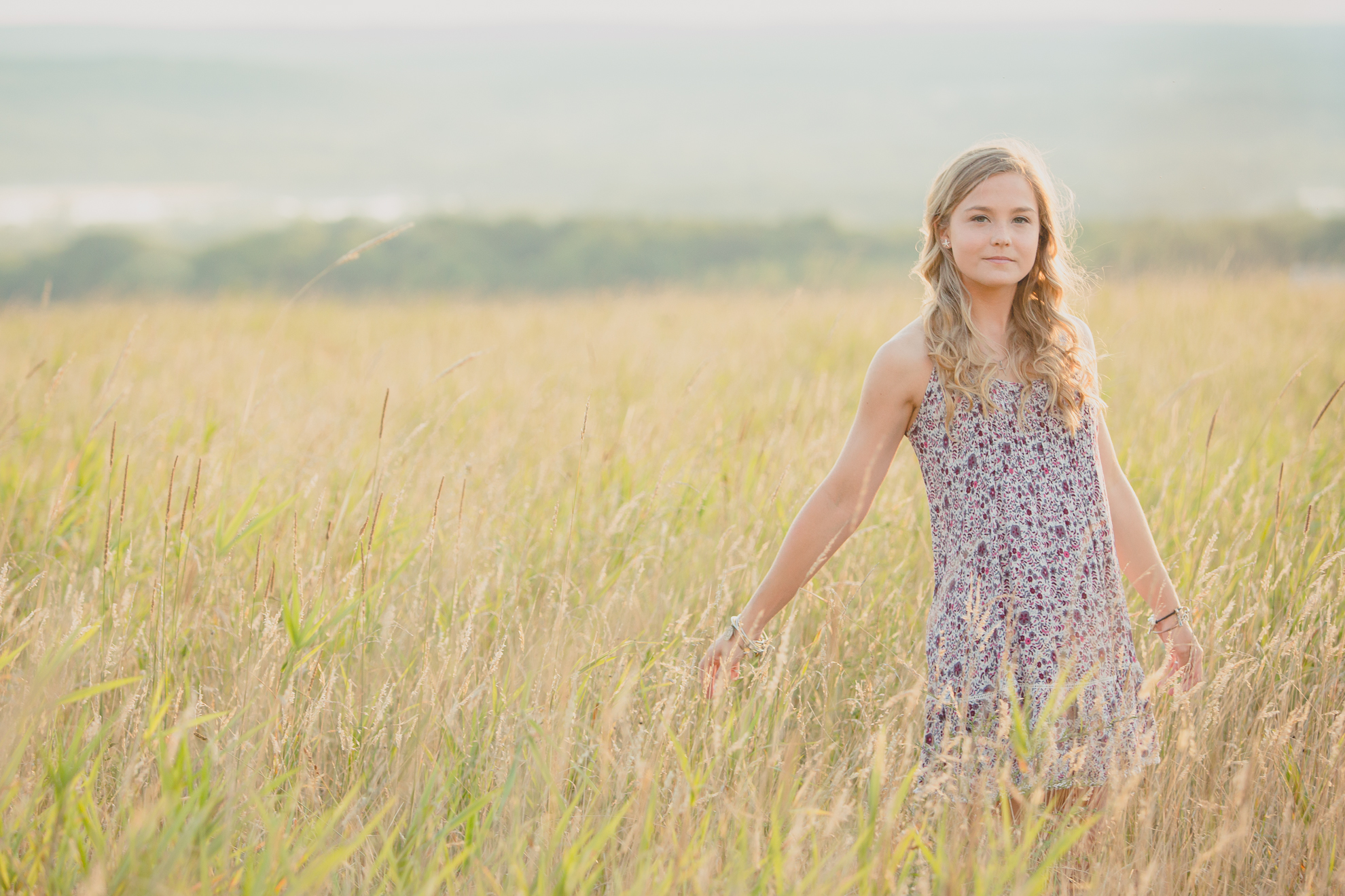 senior portrait photography of Dana in field near Buffalo, NY