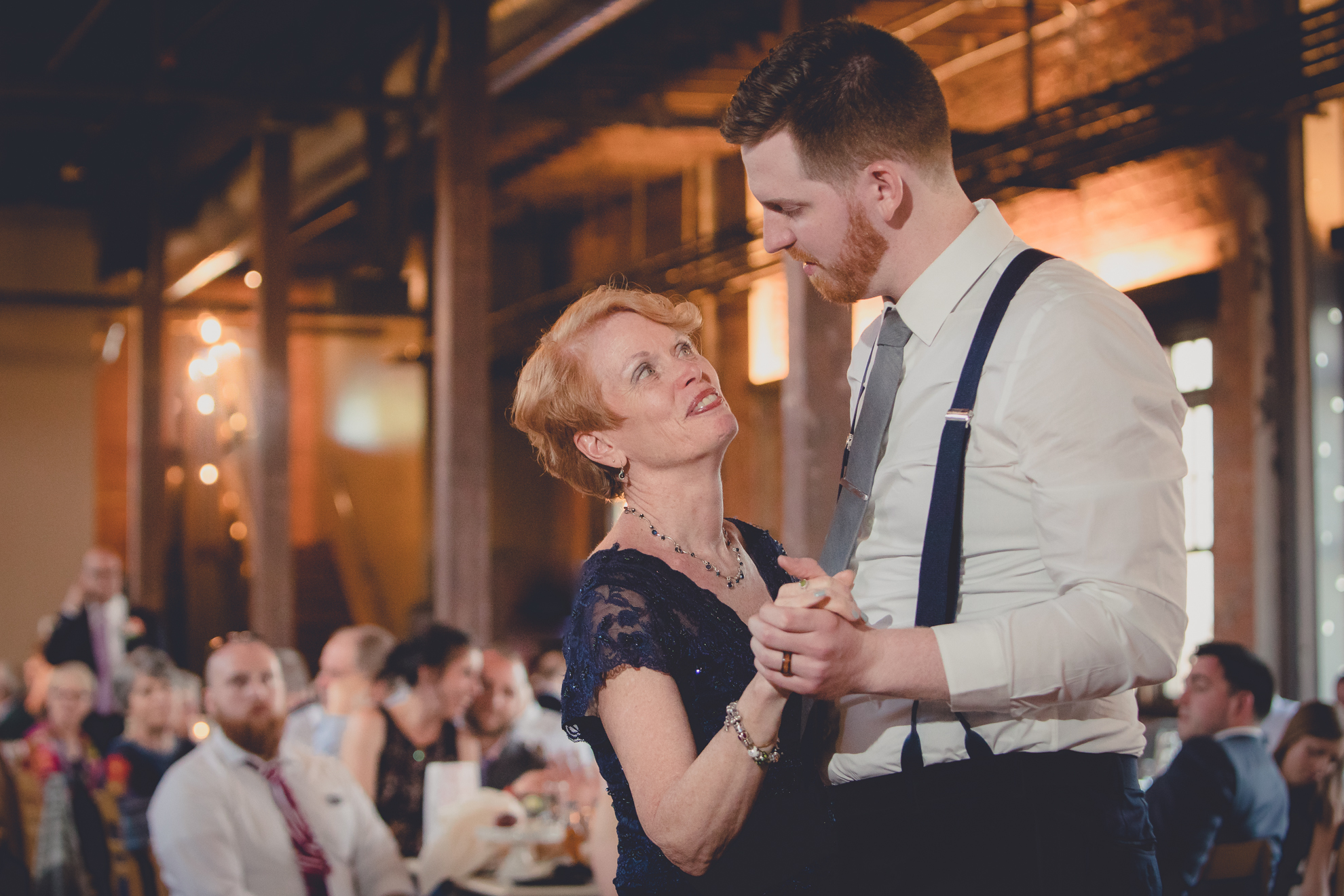 Mother and groom dance during wedding reception at the Barrel Factory in Buffalo, NY