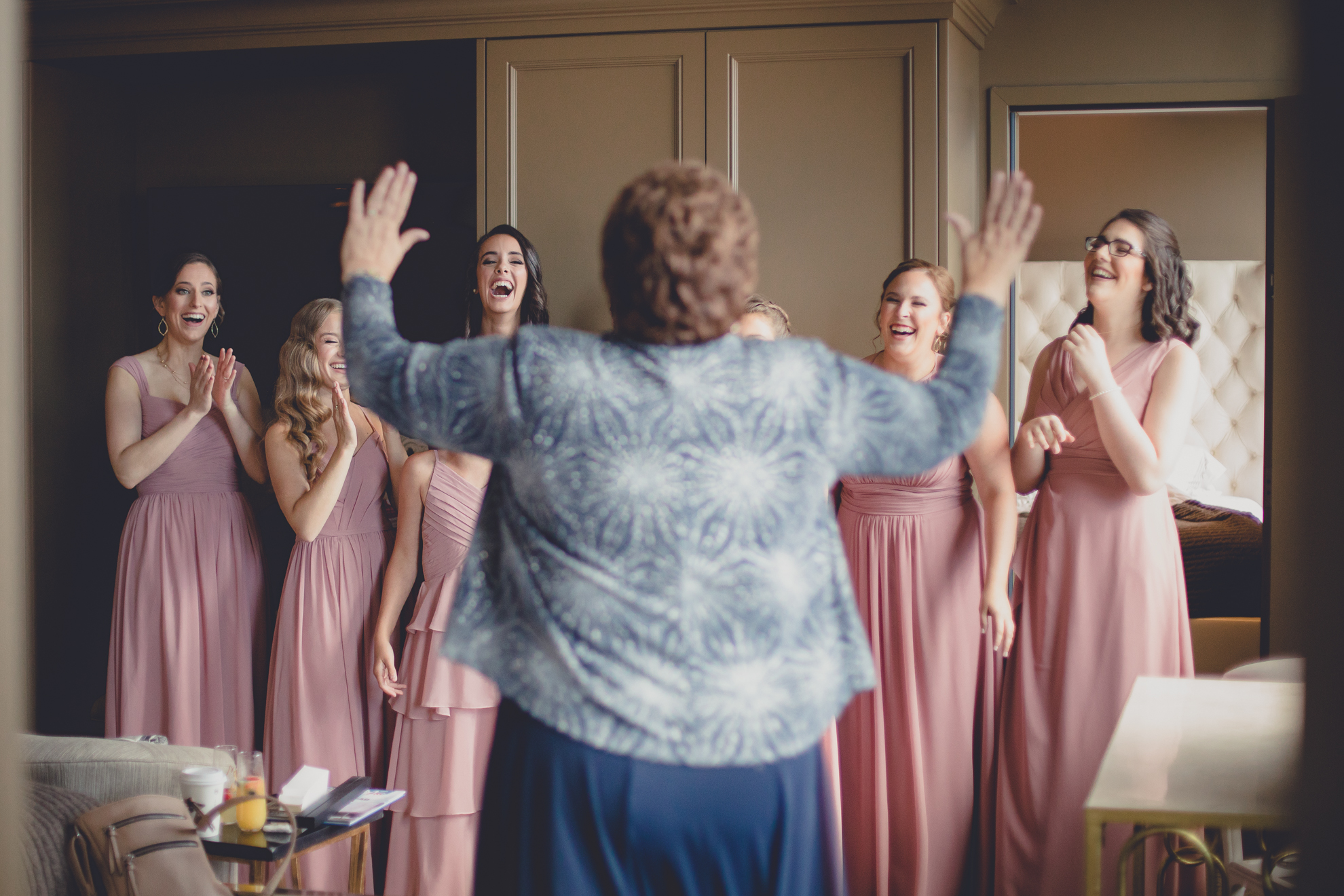 bridesmaids laugh at mom before wedding in Buffalo, NY