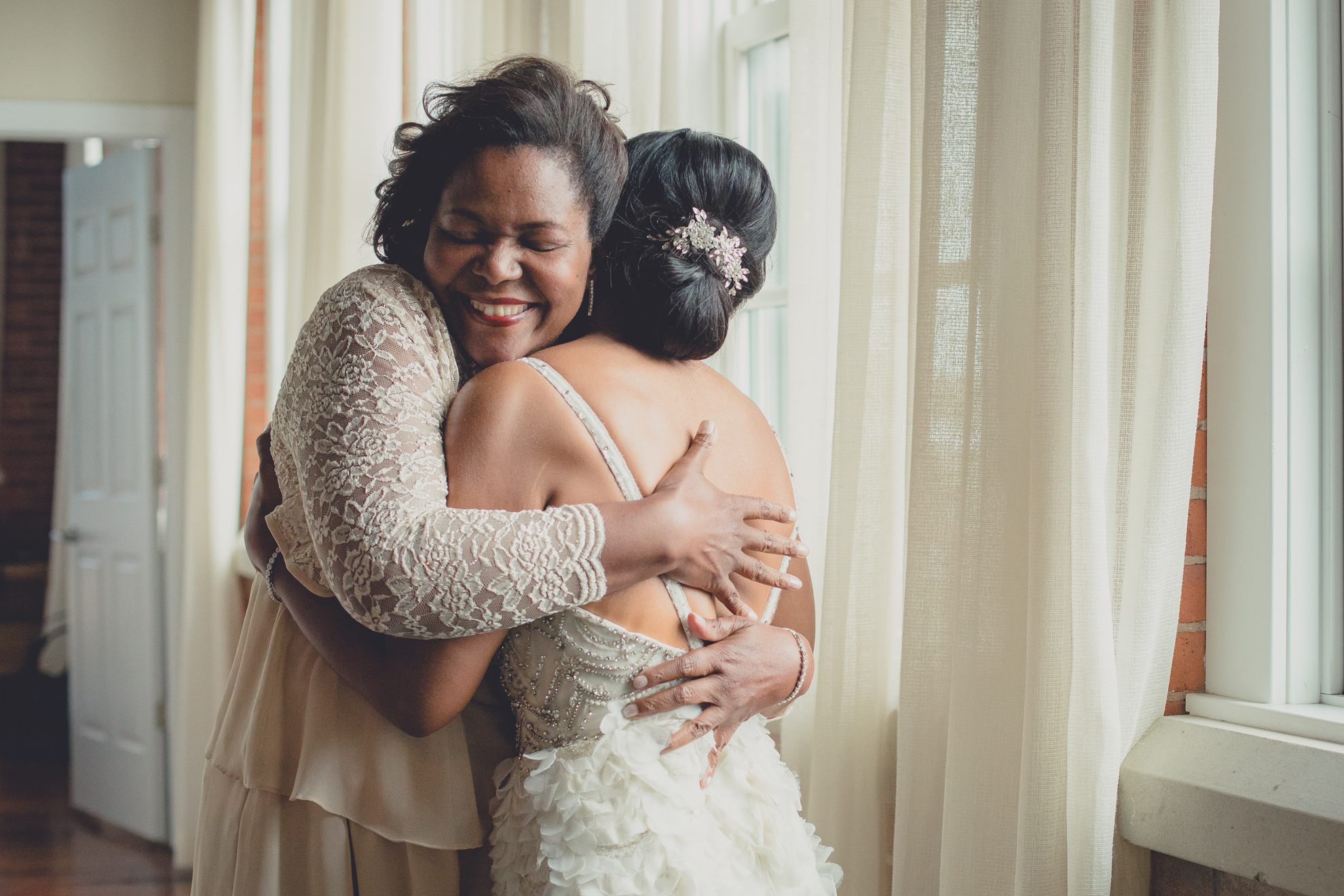 mother hugs bride before wedding at the Foundry Suites in Buffalo, NY