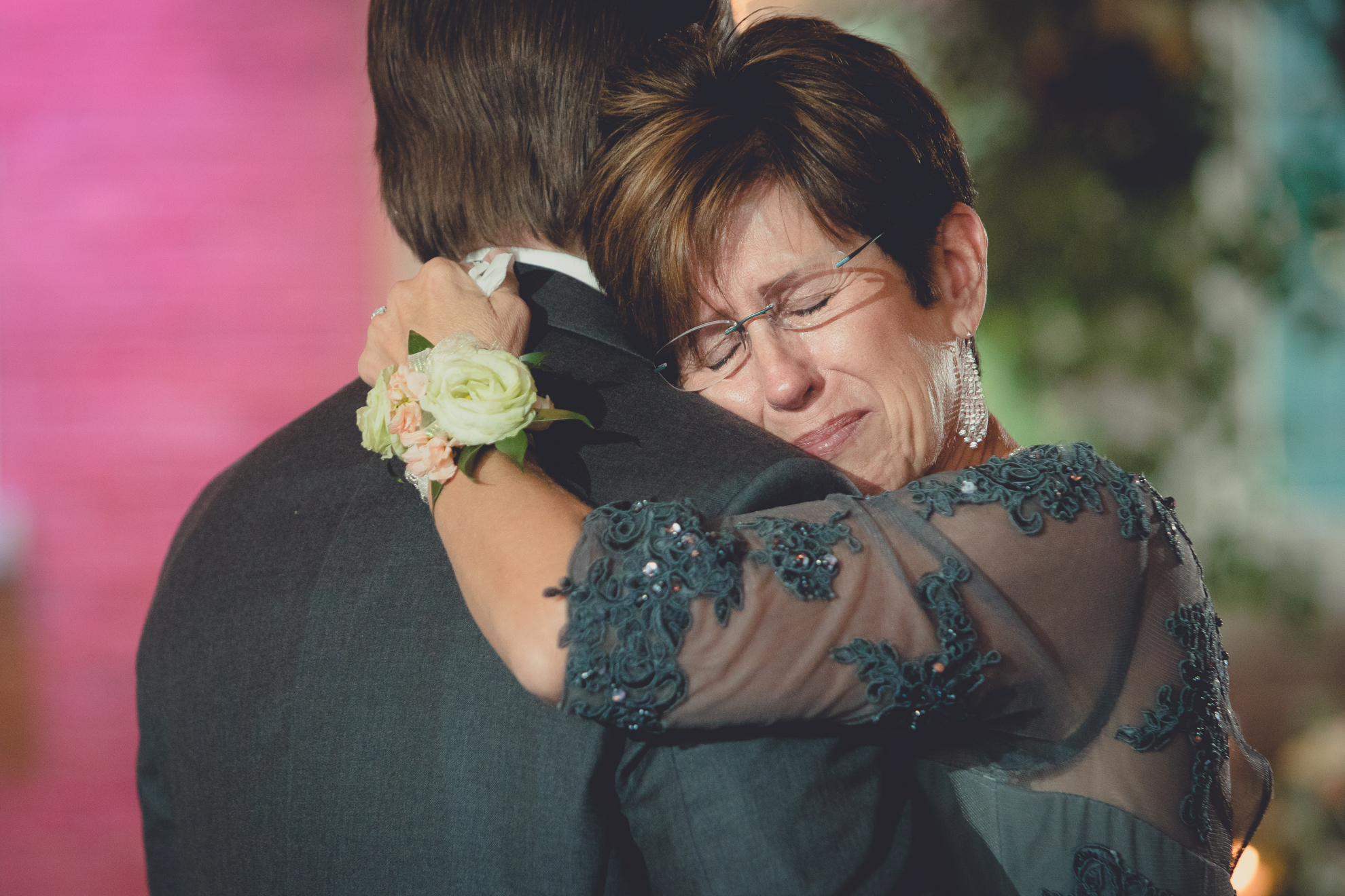 Mom cries while hugging groom during first dance at wedding reception at the Foundry Suites in Buffalo, NY