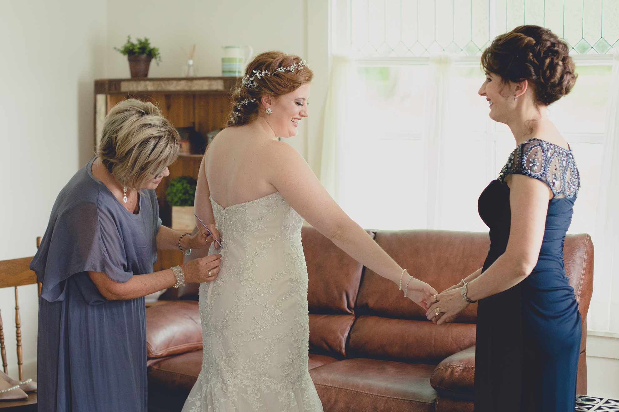 mom and aunt help bride get ready before wedding ceremony at Hayloft in the Grove near Buffalo, NY