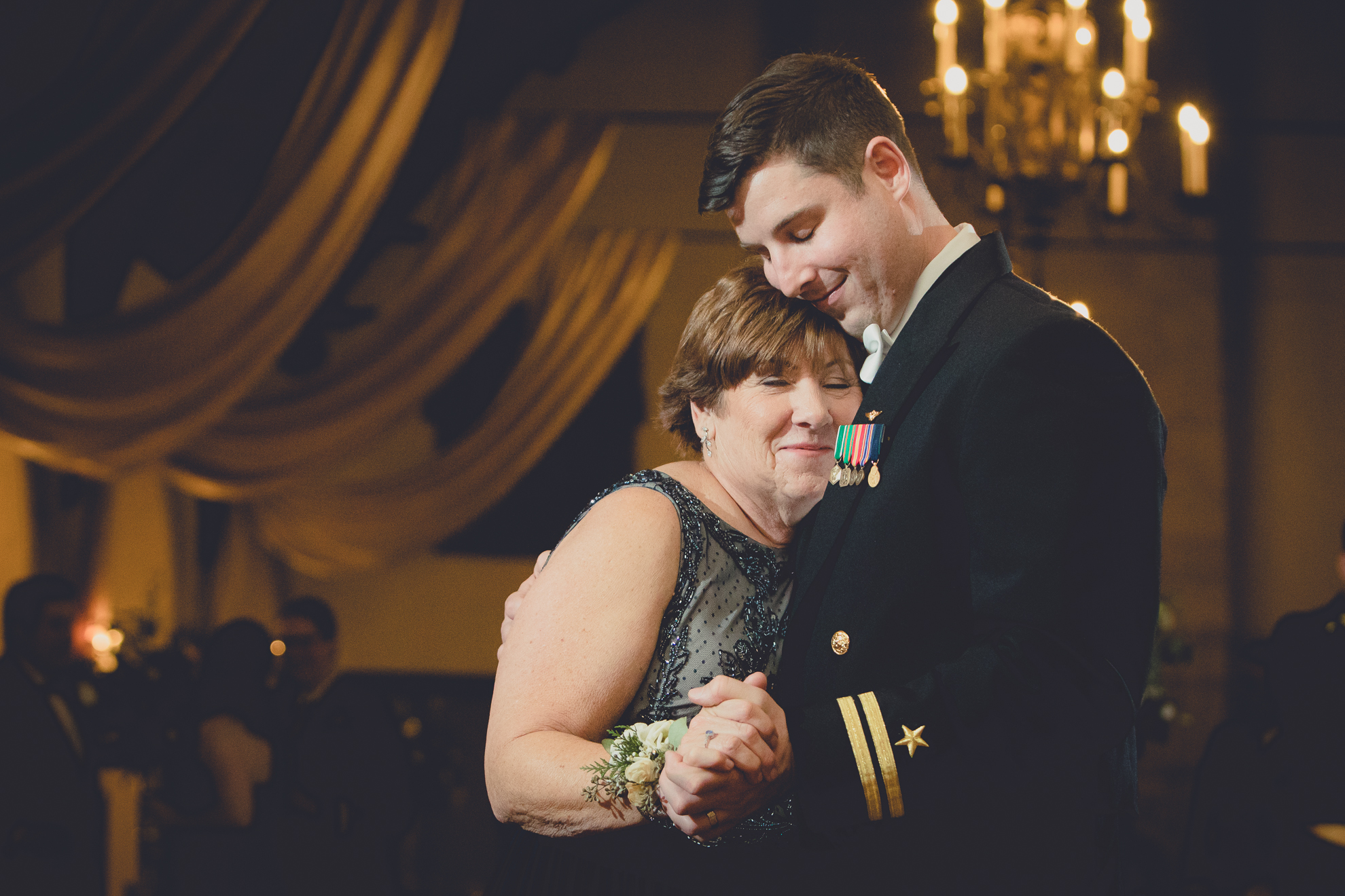 Mom cries while hugging groom during first dance at wedding reception at the Park Country Club in Buffalo, NY