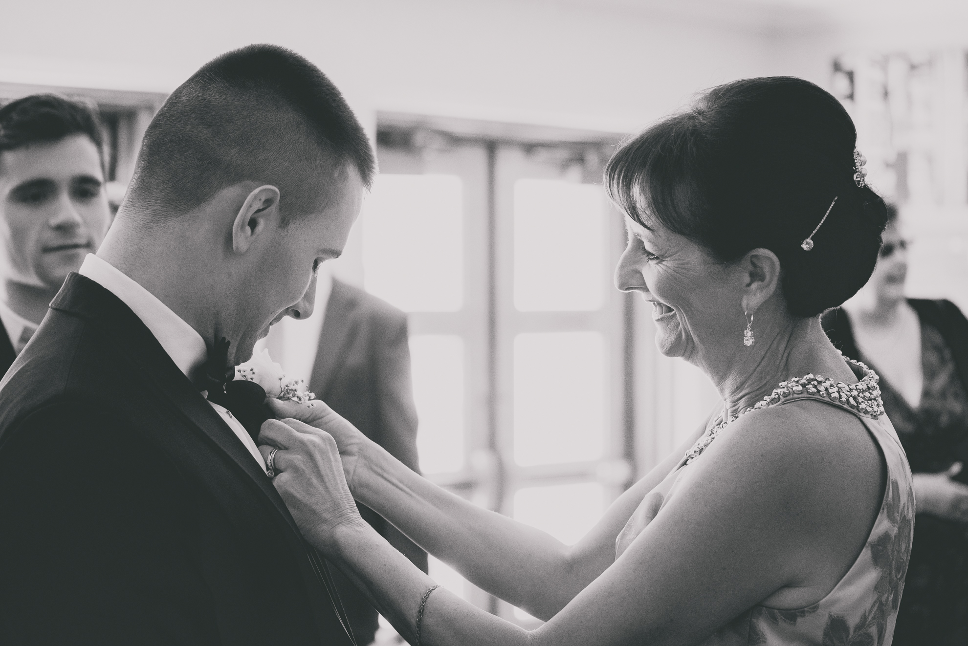 mom helps groom get ready for wedding in Buffalo, NY