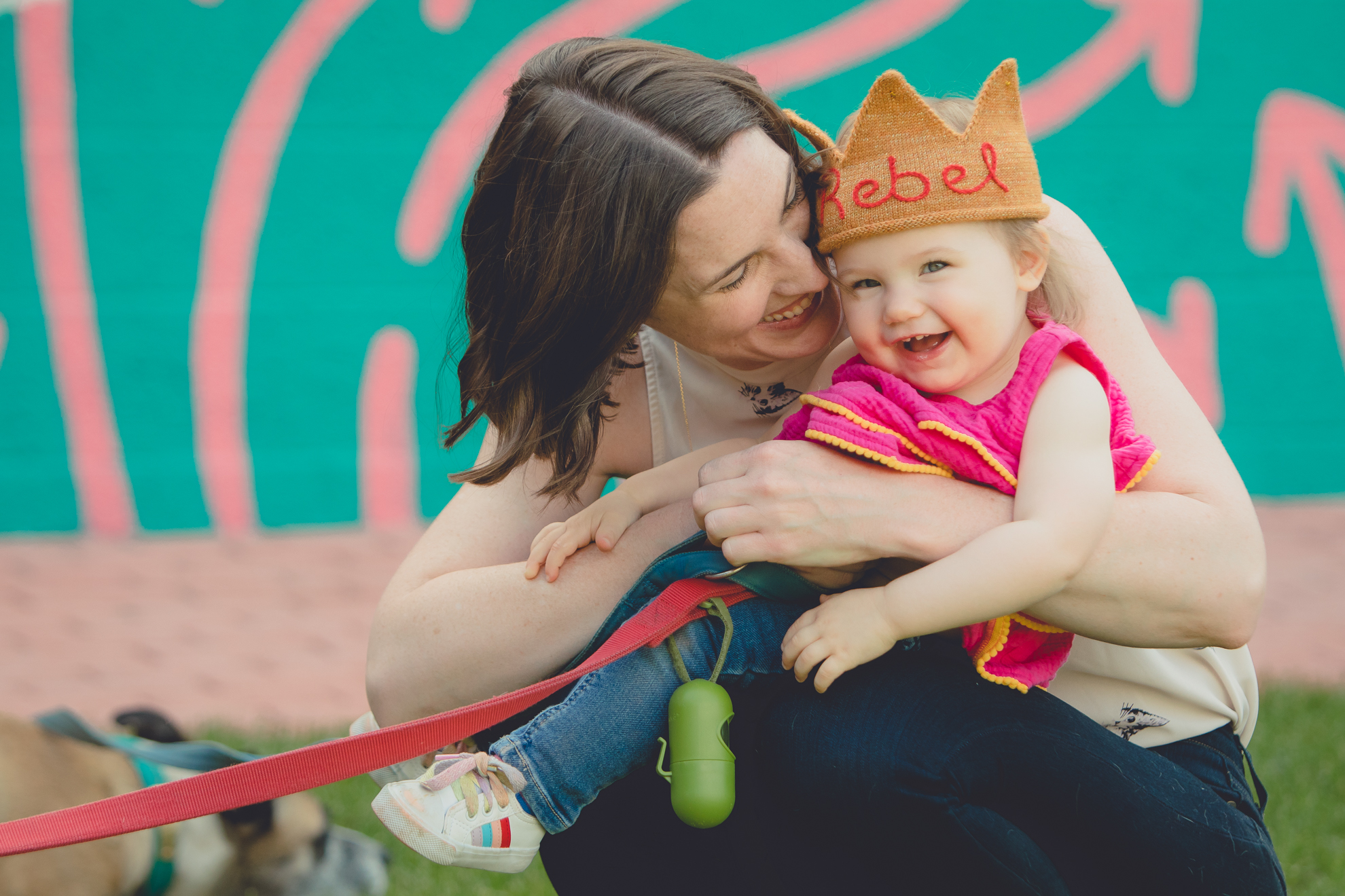 mother hugs baby in front of murals at Thin Man Chandler St. in Buffalo, NY 