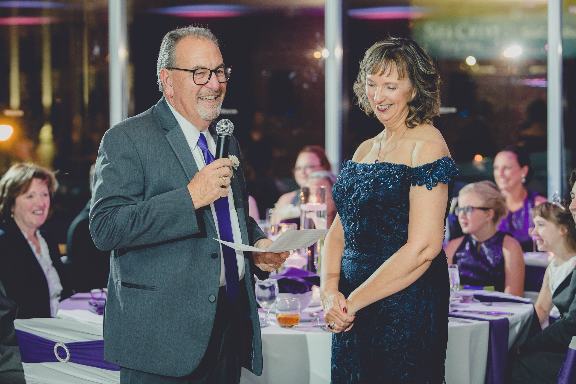 Mom laughs while dad delivers speech during wedding reception at the Westin Hotel in Buffalo, NY