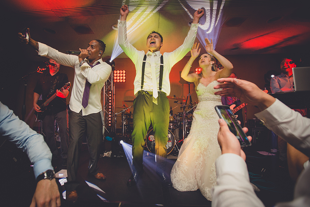 groom and bride sing with best wedding band Radio Tokyo at Buffalo Niagara Convention Center