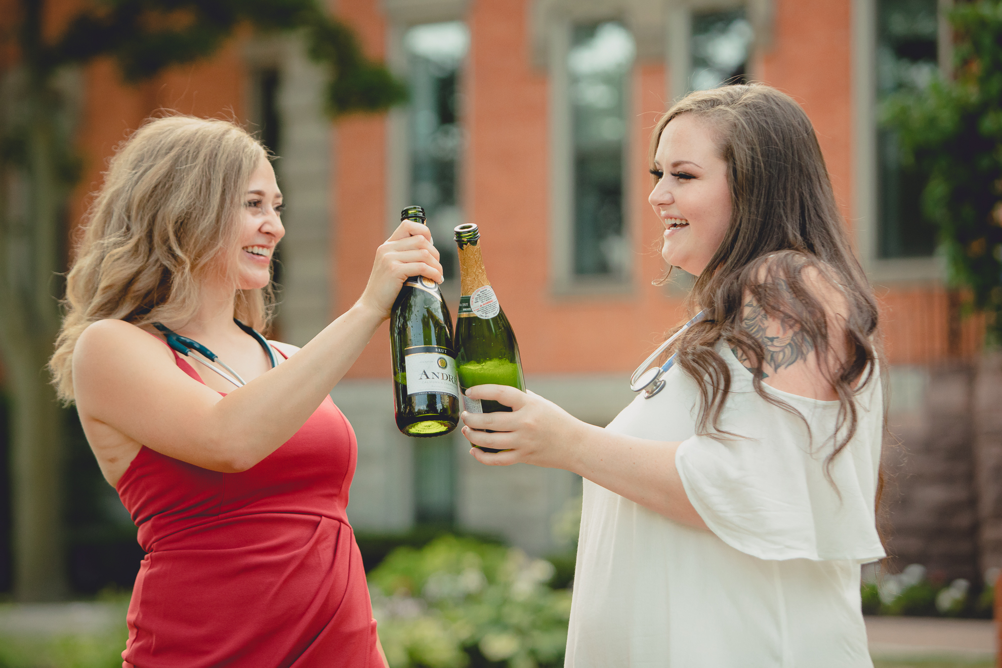 D'youville nursing students toast champagne during senior graduation portrait photography session in Buffalo, NY