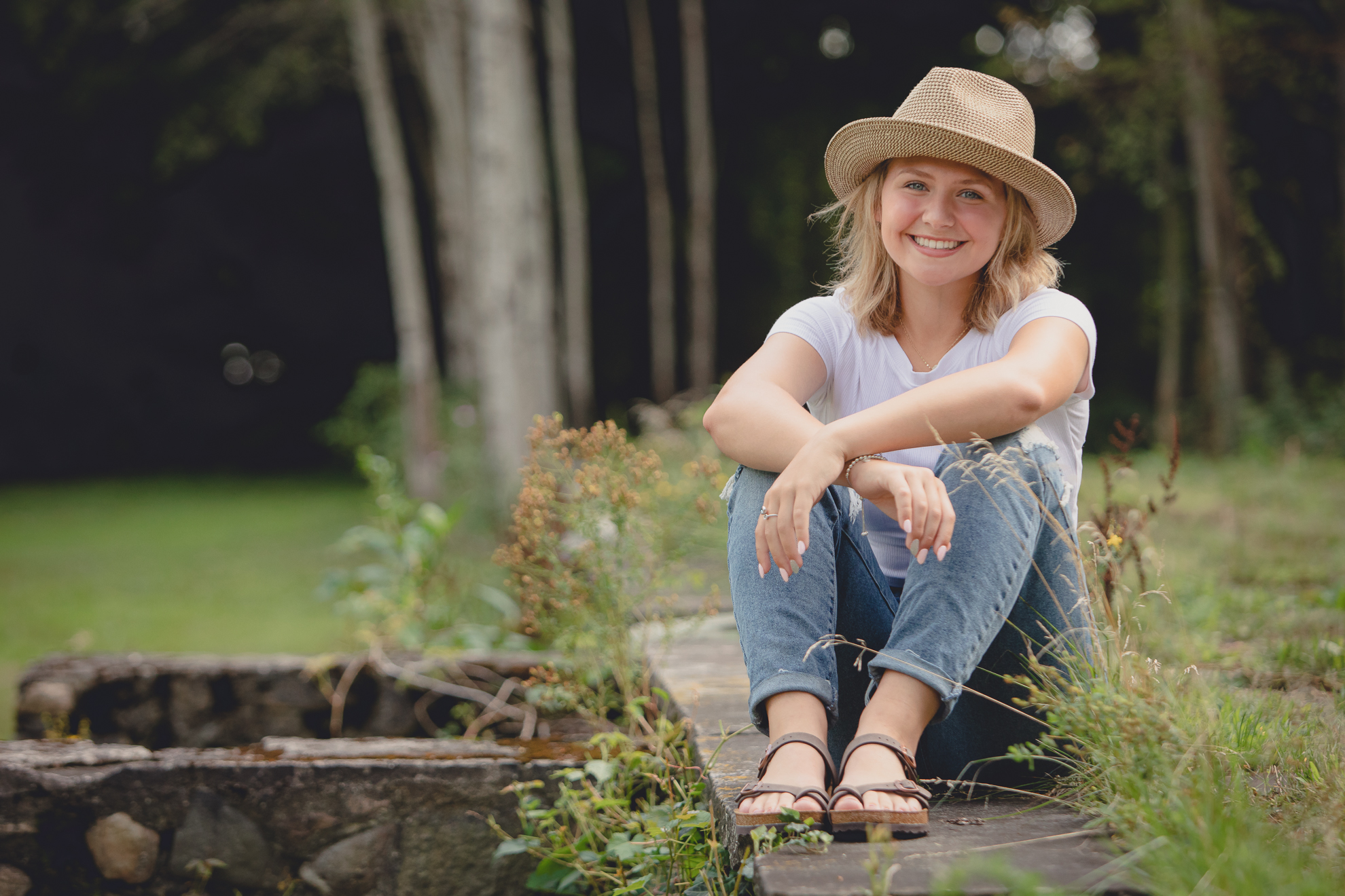 WNY senior smiles for photographer during portrait session at Long Point State Park on Lake Chautauqua in Bemus Point, NY