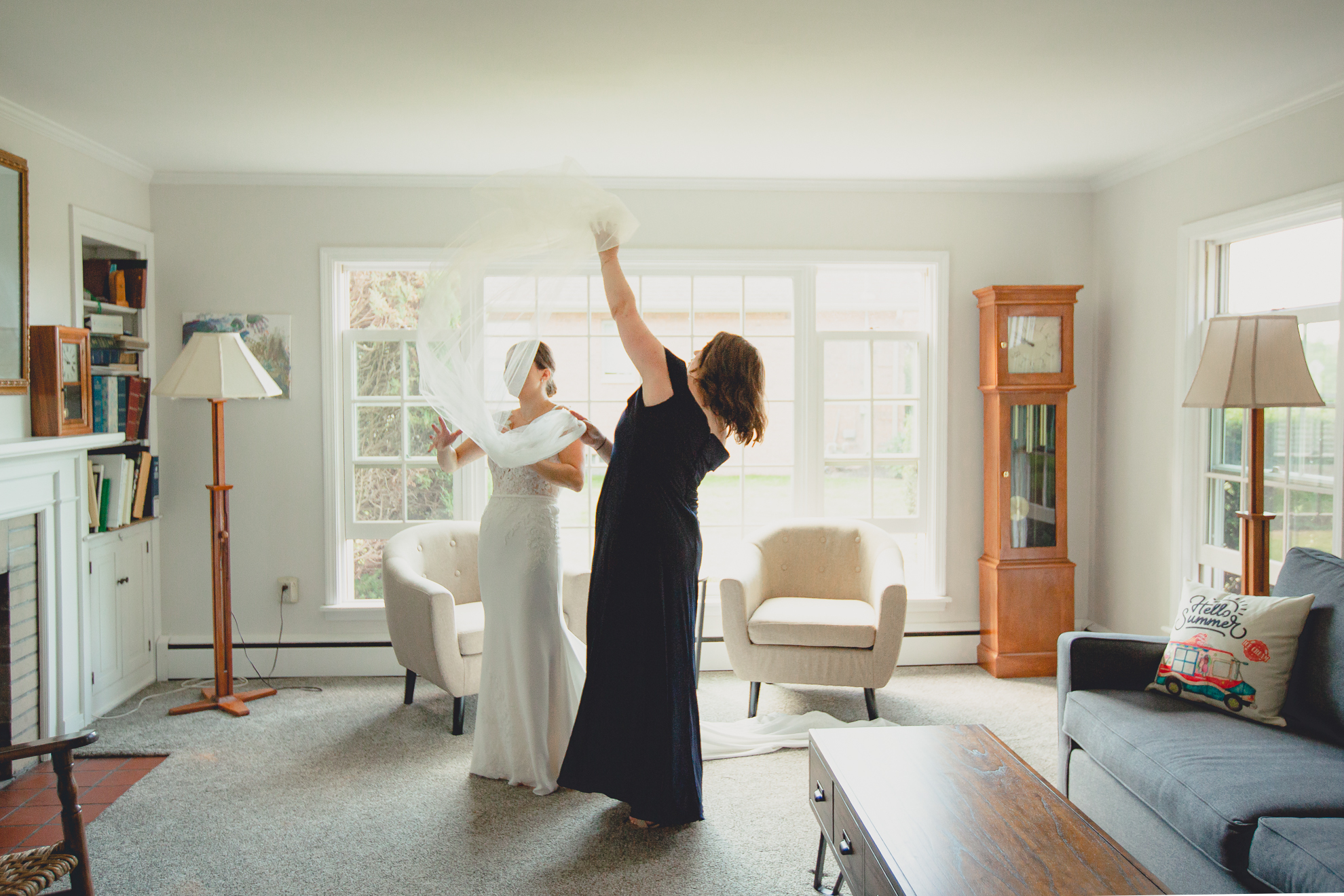 matron of honor helps bride with veil before micro wedding in WNY