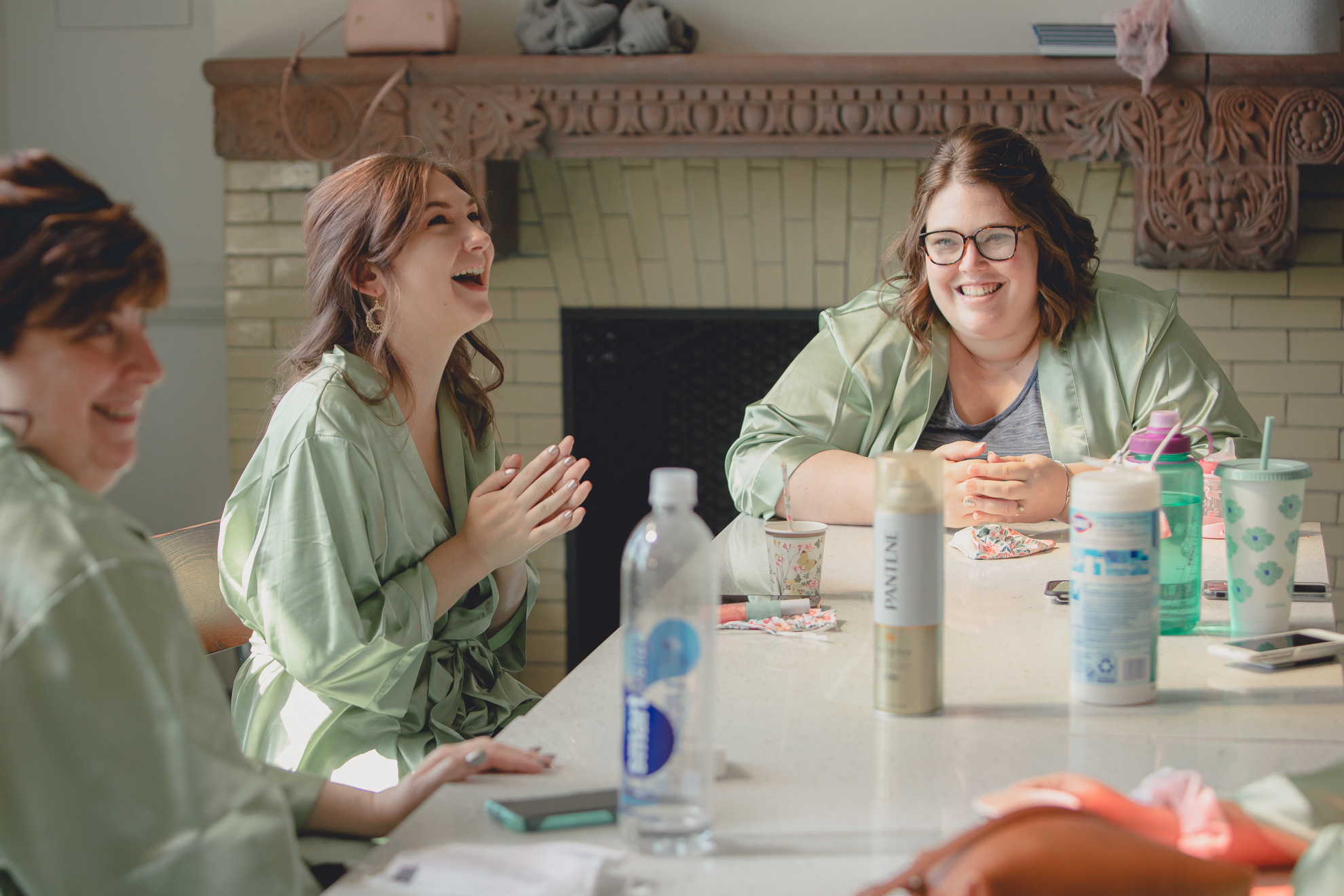 bridesmaids laugh at table before wedding at Hotel Henry in Buffalo, NY