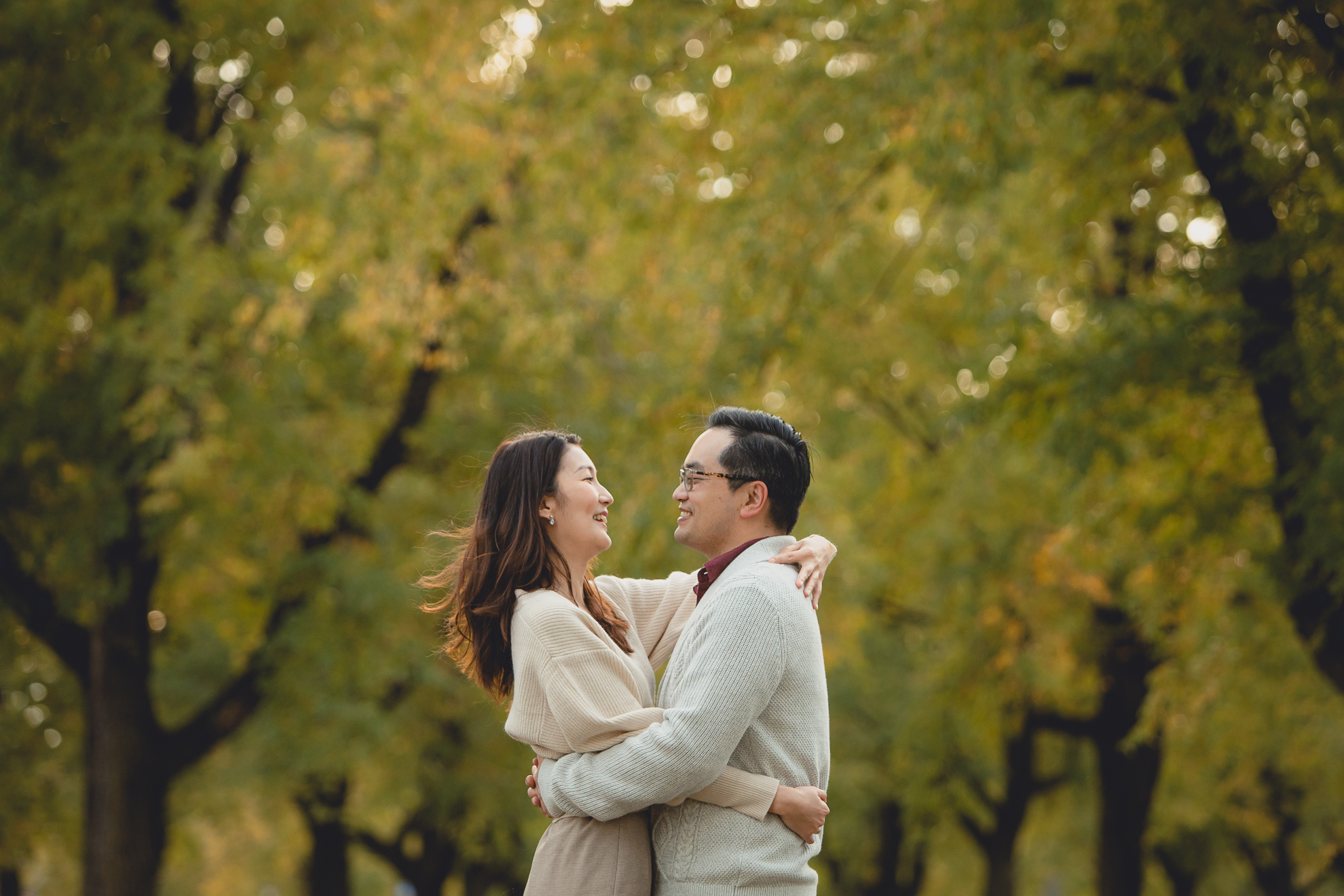 bride and groom pose for engagement photos among fall foliage in Bidwell Parkway in Buffalo, NY