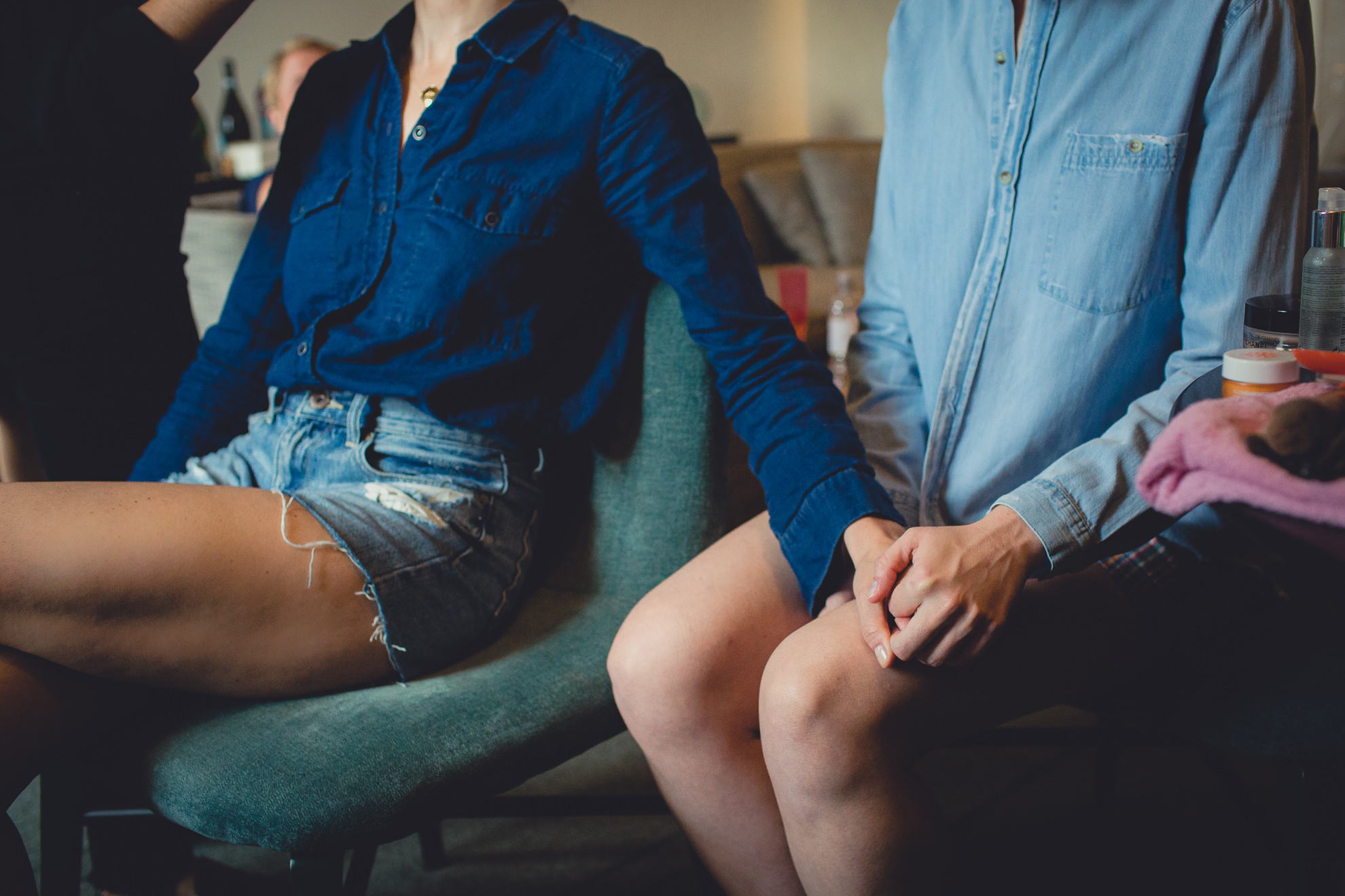 brides hold hands while getting ready for wedding at Hotel Henry in Buffalo, NY