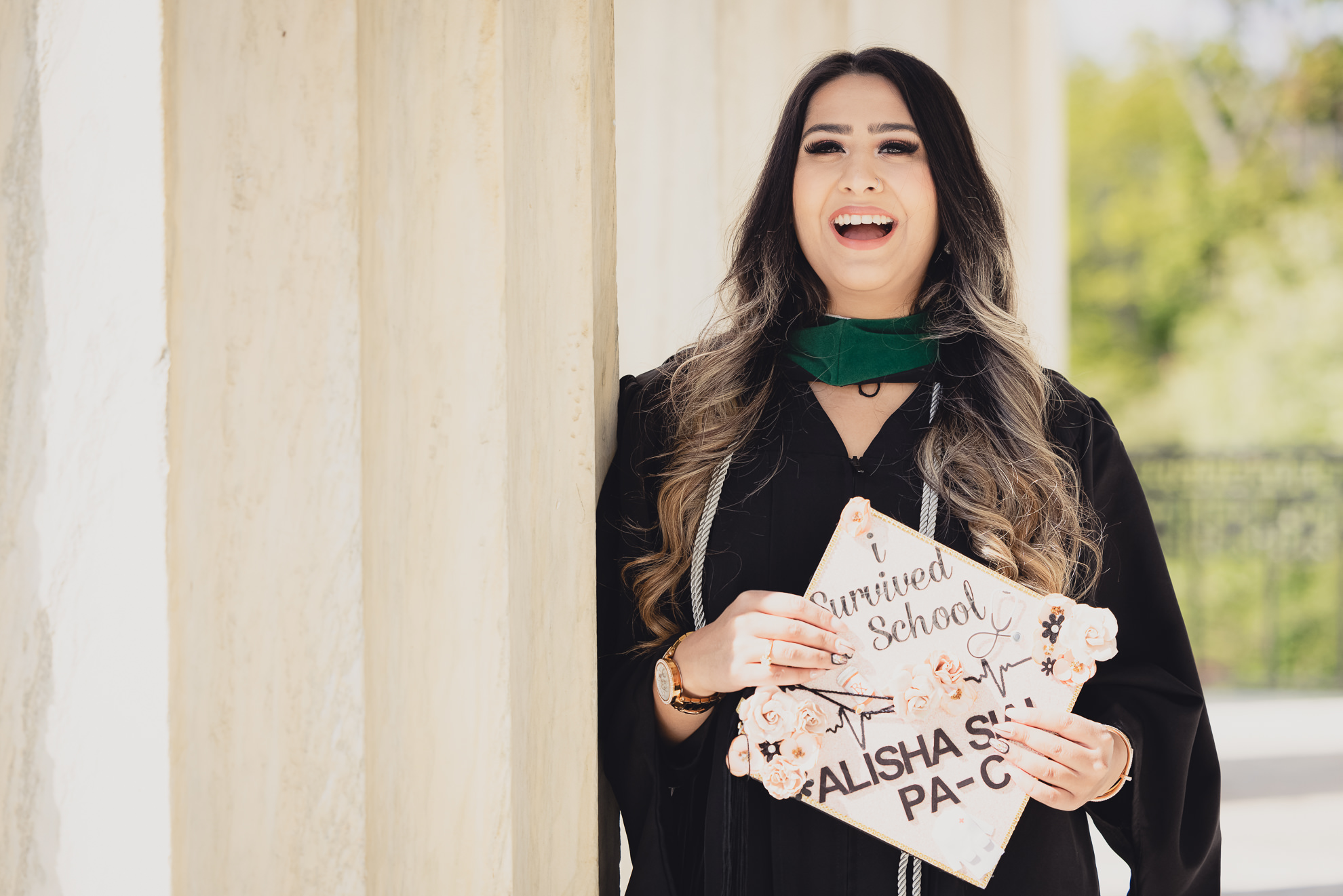 graduate laughs for photographer during senior graduation portrait photography at the History Museum in Buffalo, NY