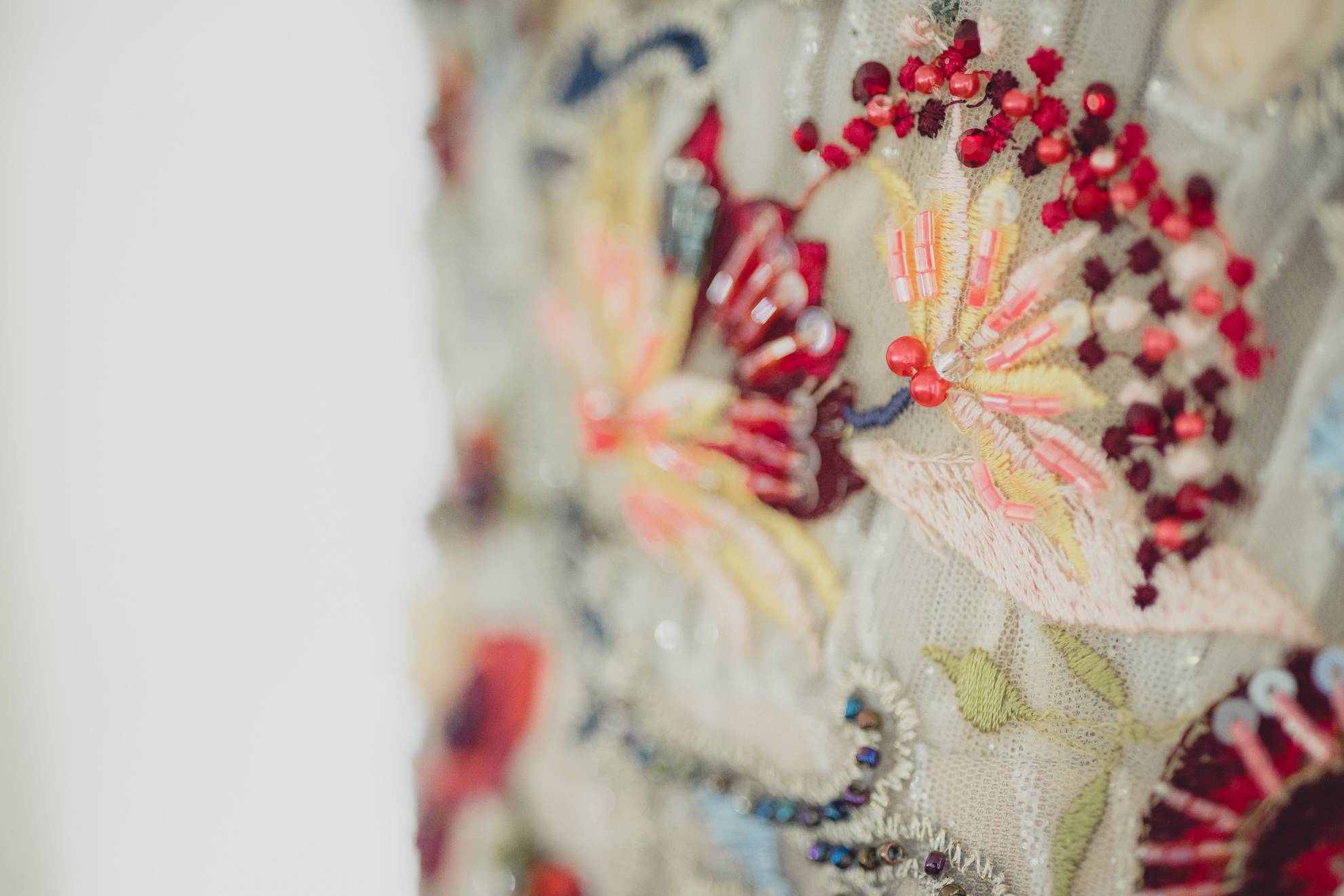 hand sewn beading and embroidery on wedding dress pictured before outdoor tented wedding at the mansion at Knox Farm in East Aurora, NY