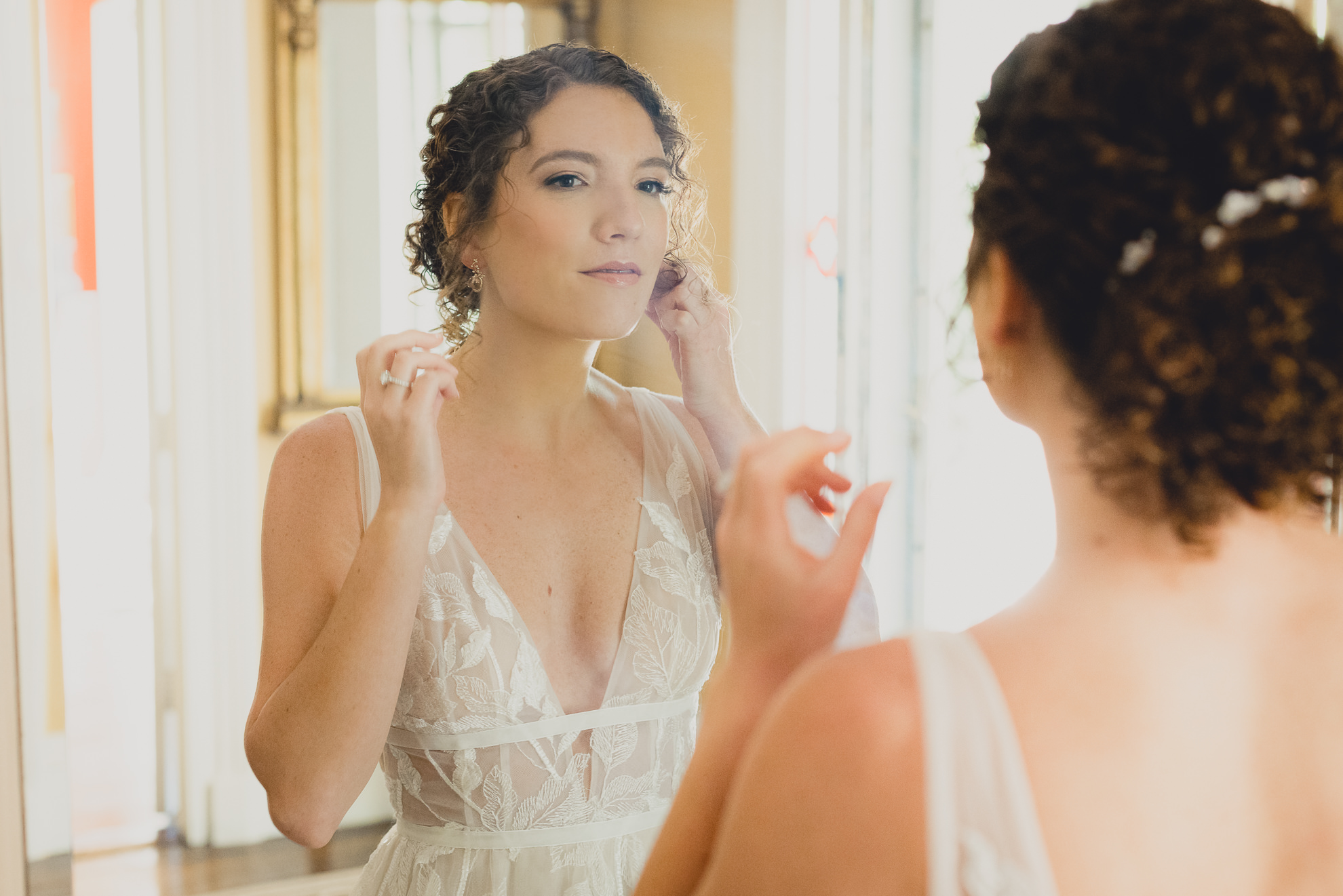 bride puts earrings in at Barton Hill House in Lewiston, NY before wedding