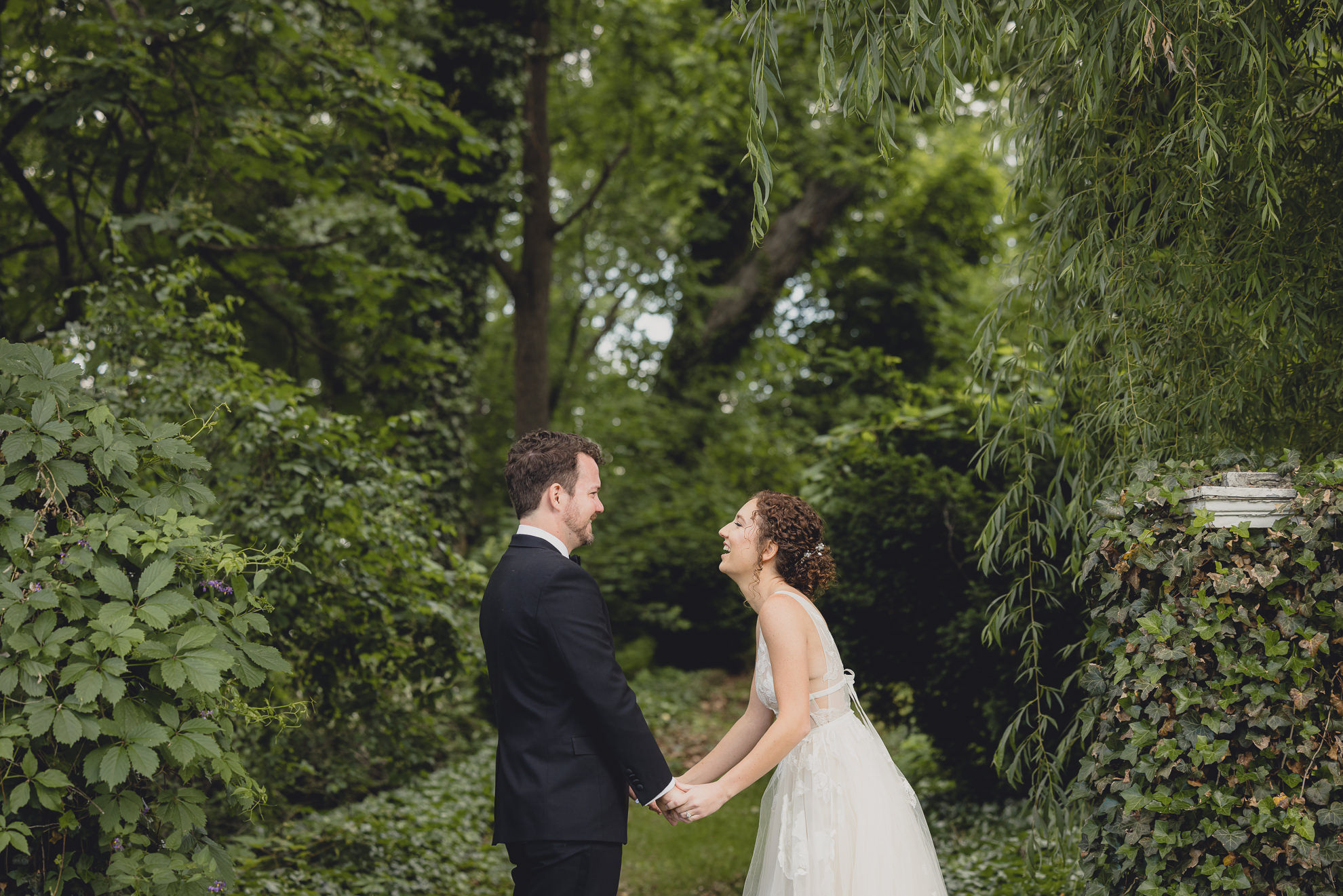 bride and groom laugh at Barton Hill House in Lewiston, NY before wedding