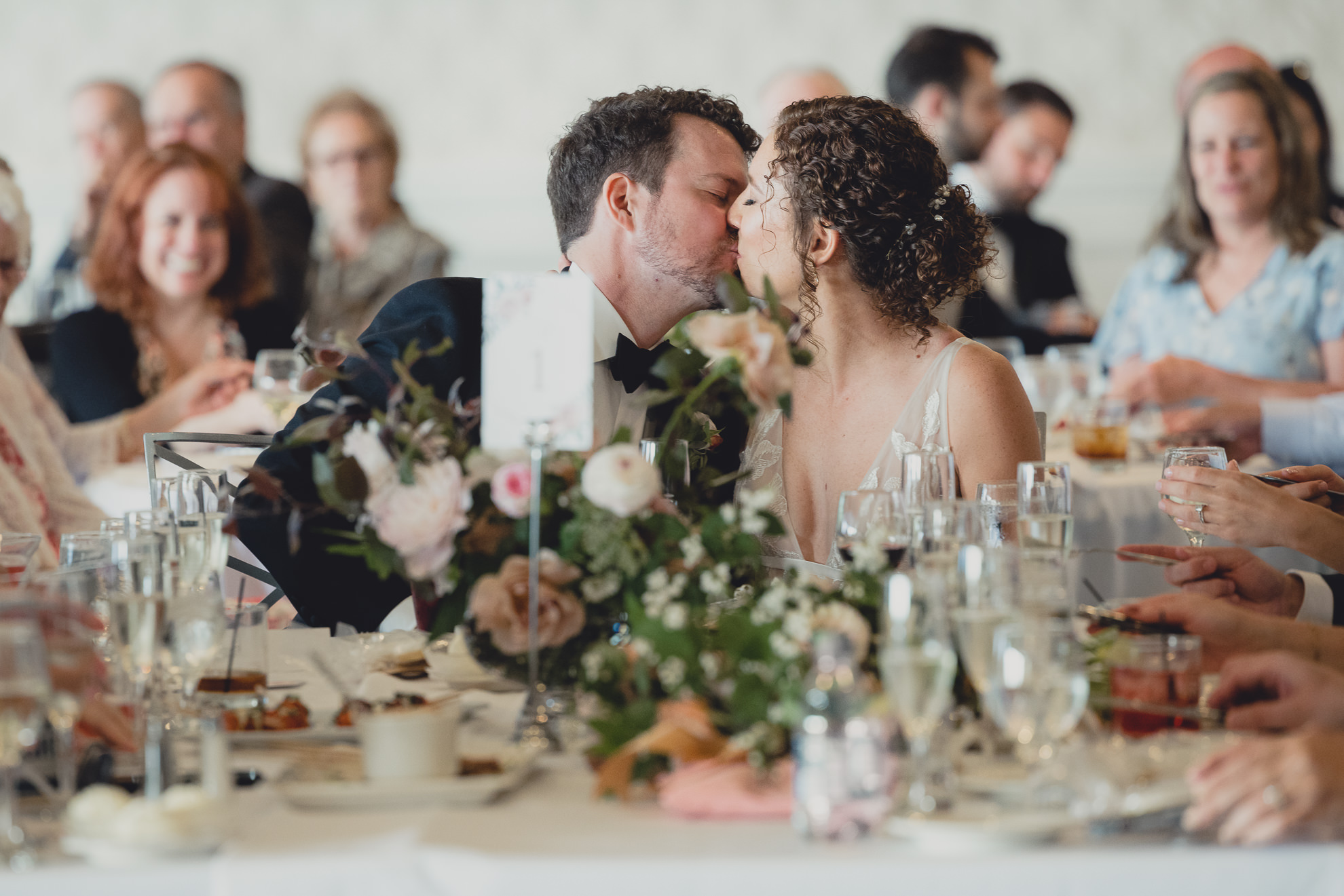 bride and groom kiss during wedding reception at the Niagara Falls Country Club