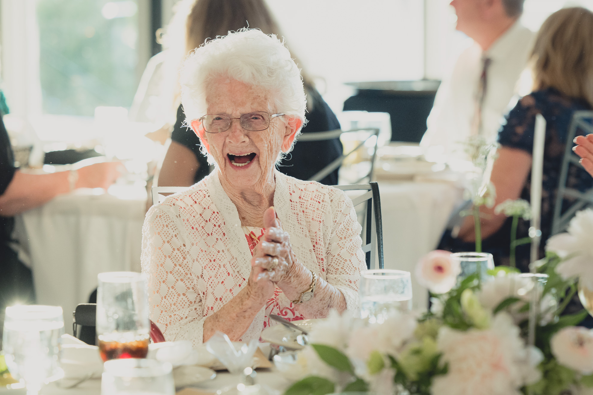 grandmother of bride laughs during wedding reception at the Niagara Falls Country Club