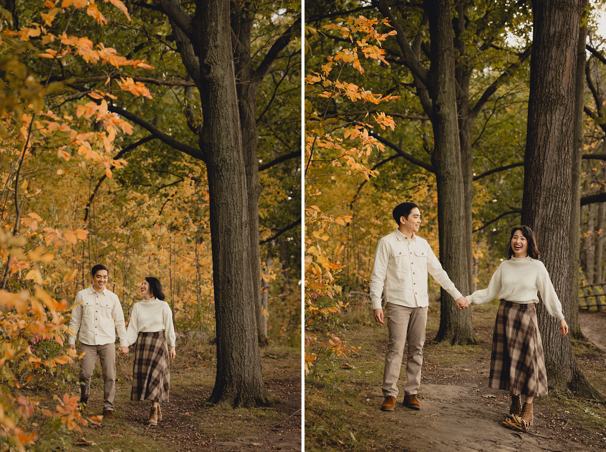 couple laughs while walking and holding hands with fall foliage in background during wedding engagement photography session in Niagara Falls, NY
