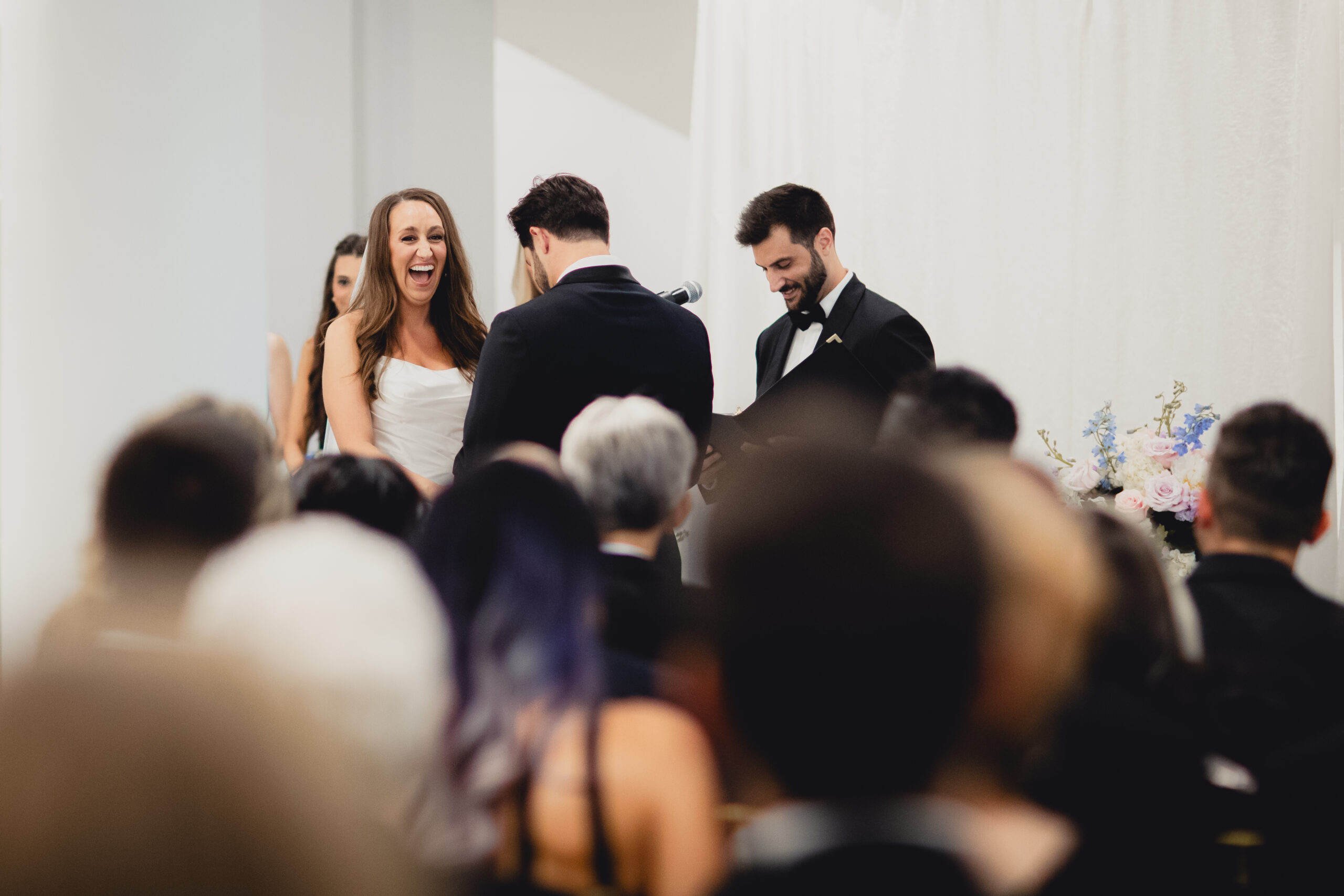bride laughs during wedding ceremony in the Portico Gallery of the Buffalo History Museum