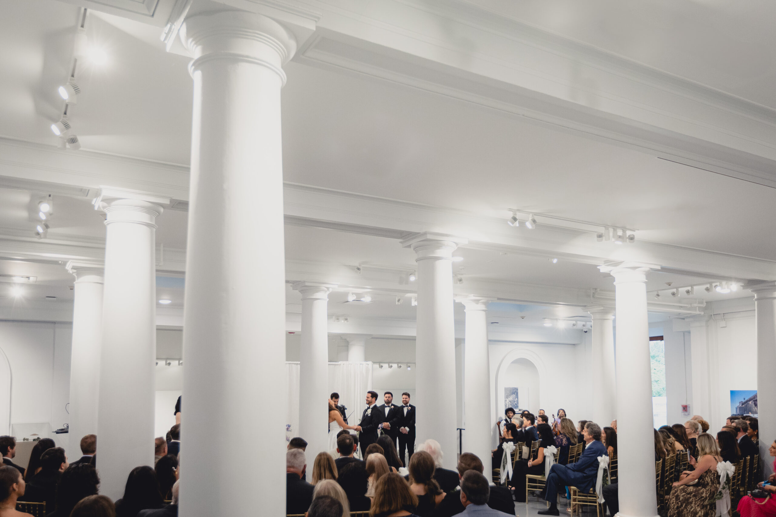 wide angle photo of wedding ceremony in the Portico Gallery of the Buffalo History Museum
