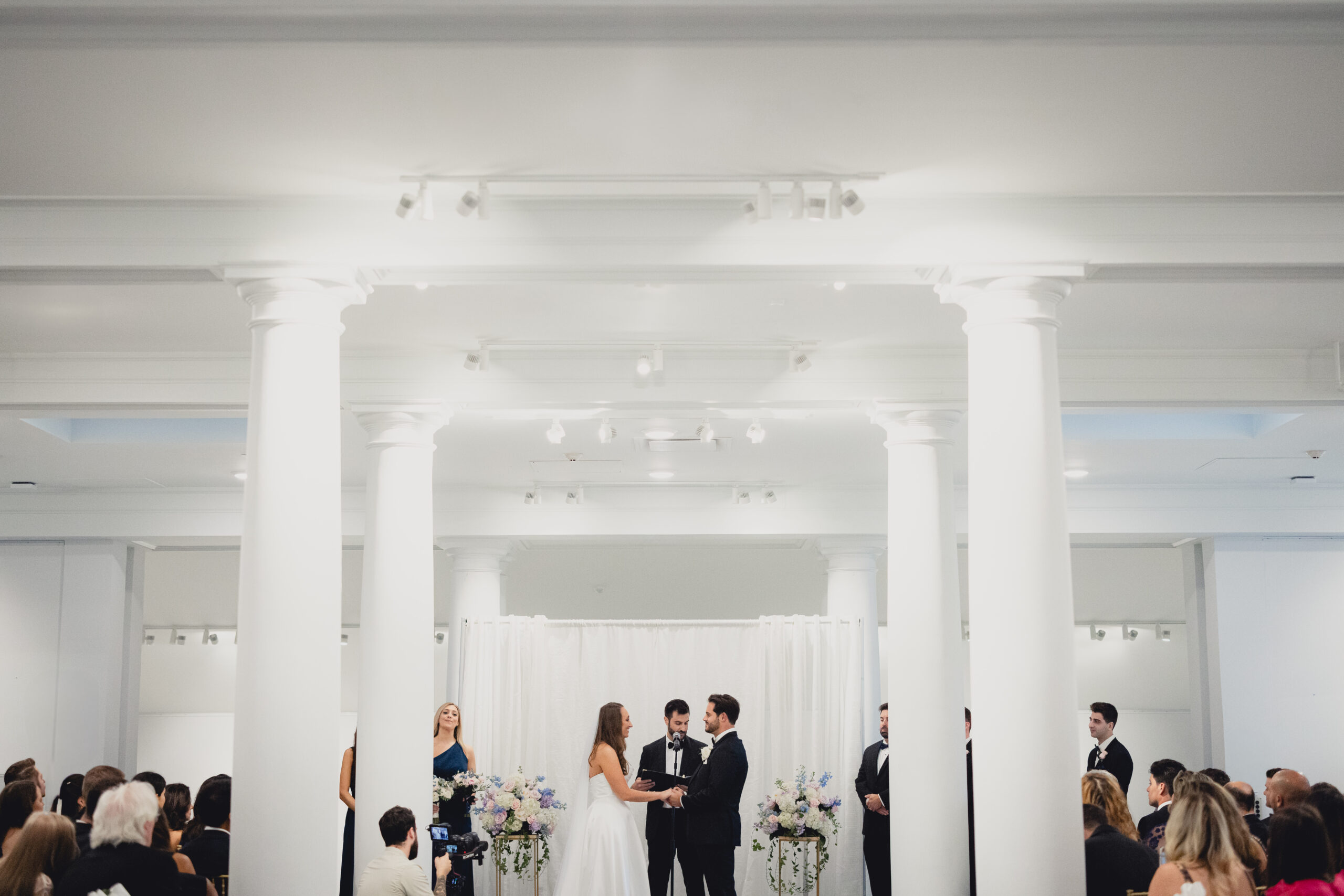 bride and groom exchange vows during wedding ceremony in the Portico Gallery of the Buffalo History Museum