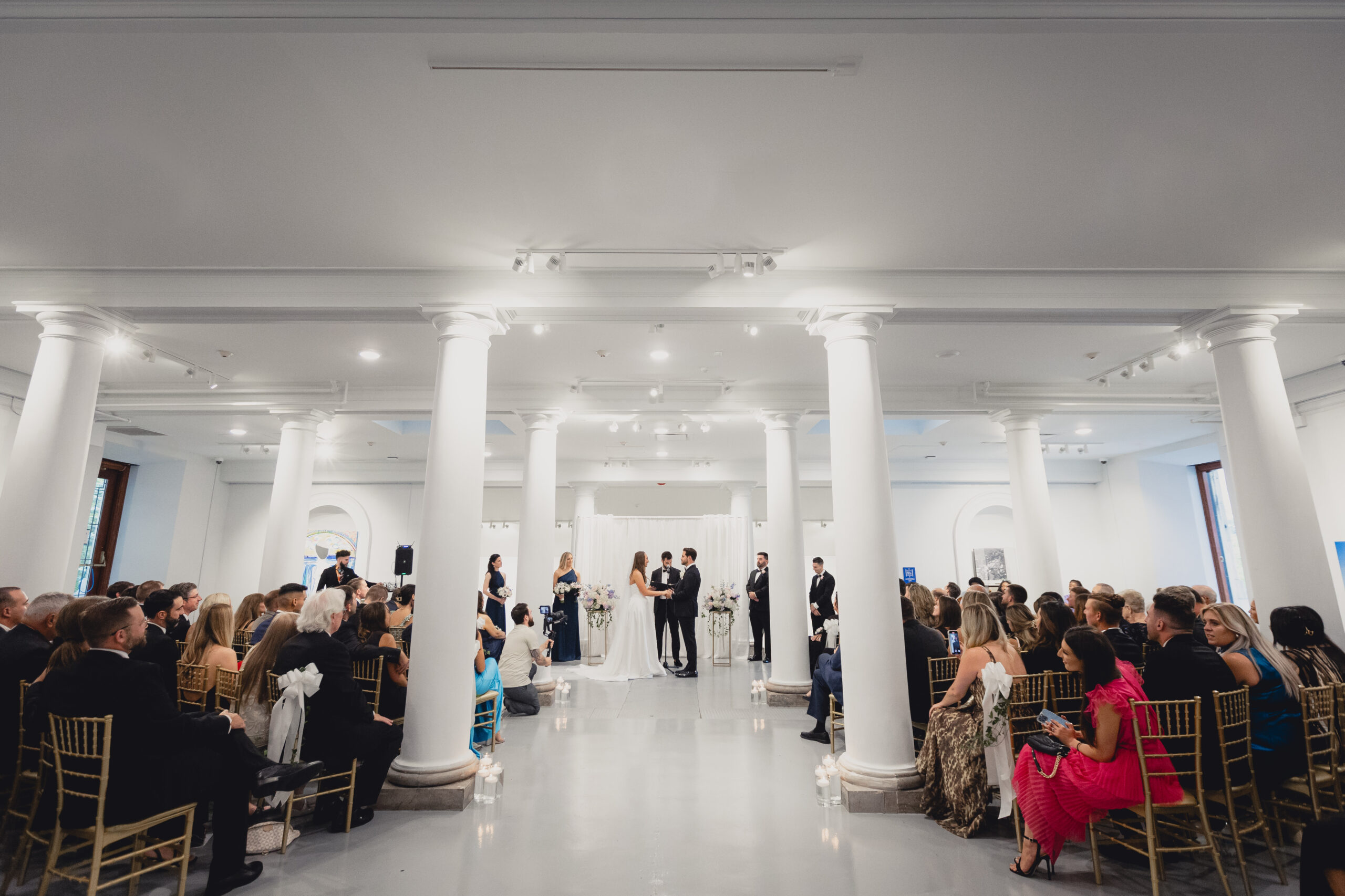 bride and groom exchange vows during wedding ceremony in the Portico Gallery of the Buffalo History Museum