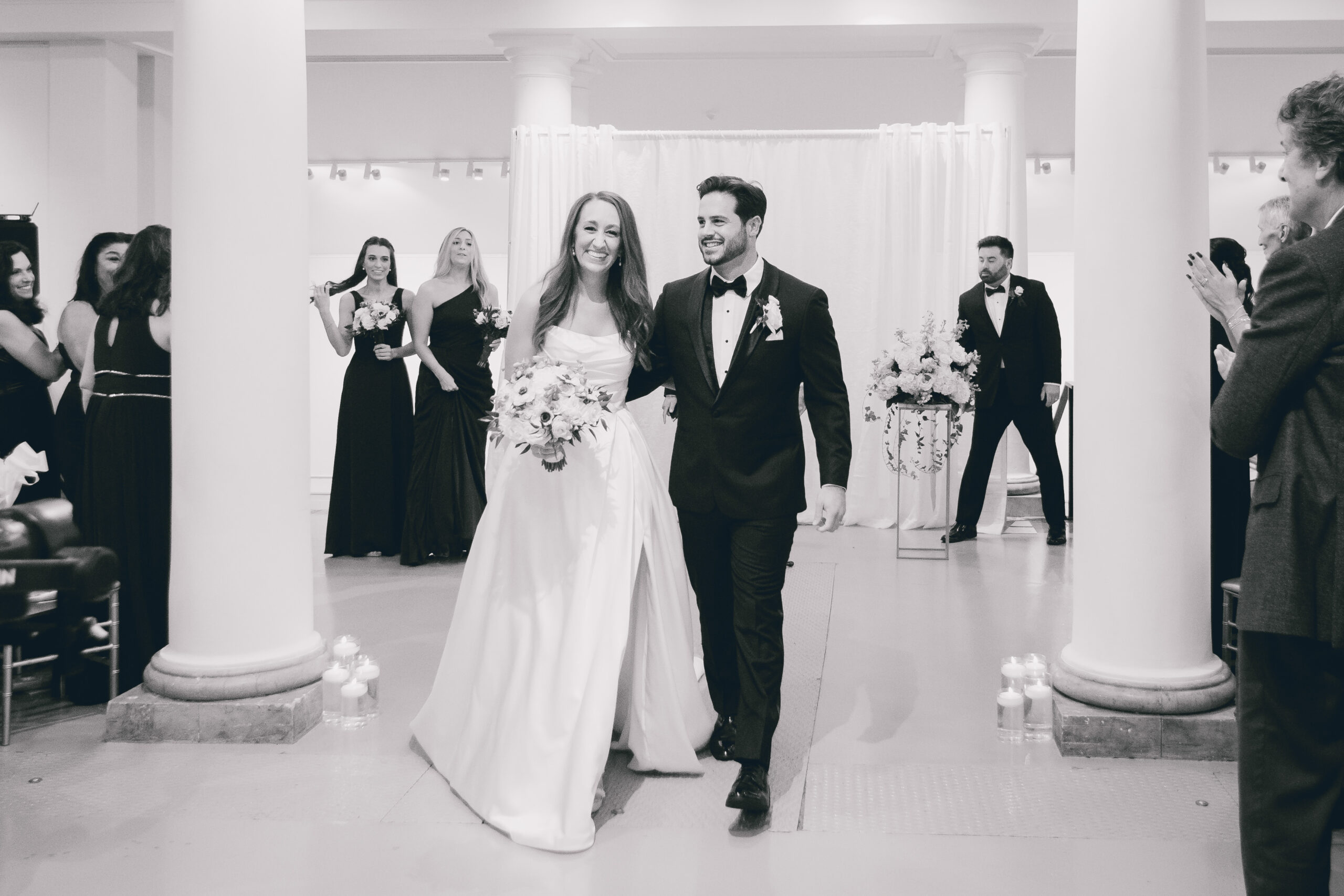 couple exits wedding ceremony in the Portico Gallery of the Buffalo History Museum
