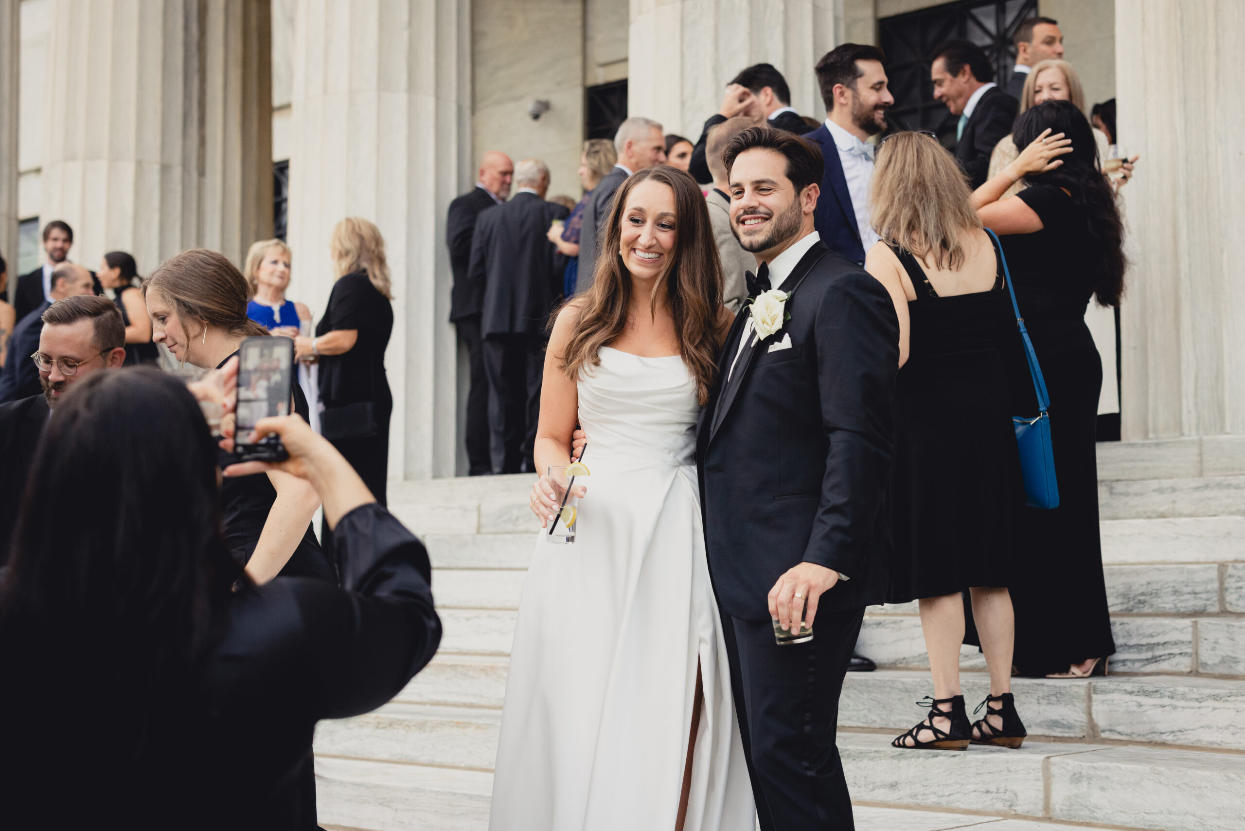 bride and groom pose for picture during wedding reception at the Buffalo History Museum