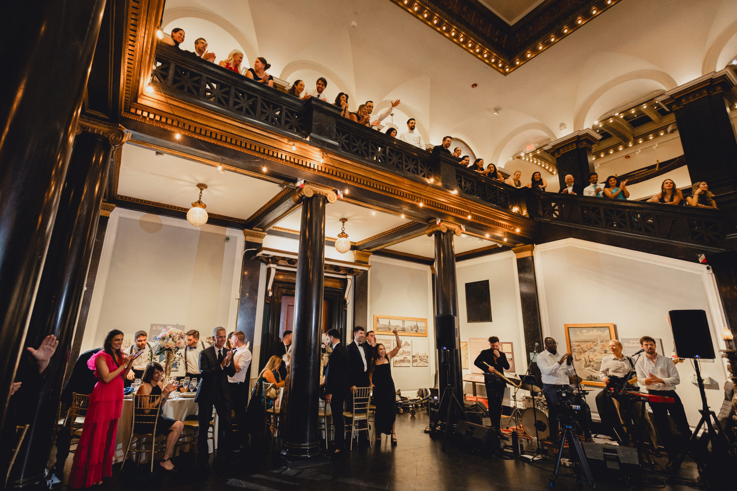 guests cheer for bride and groom during entrances during wedding reception at the Buffalo History Museum