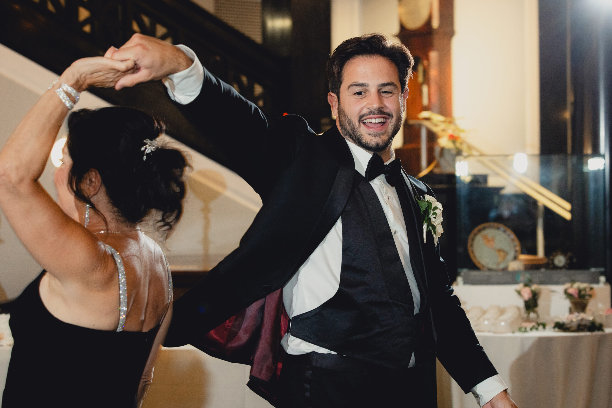 groom dances with mom during wedding reception at the Buffalo History Museum