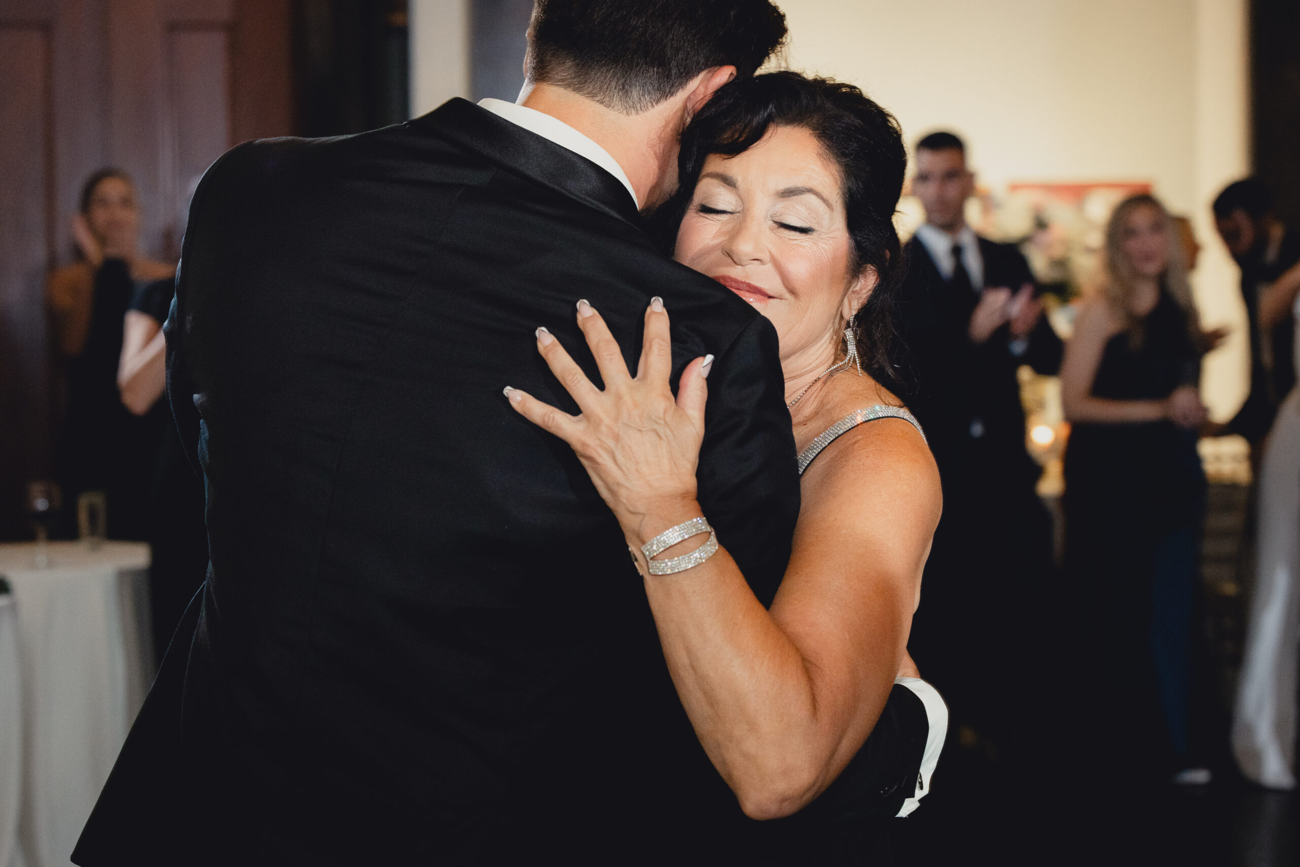 groom dances with mom during wedding reception at the Buffalo History Museum