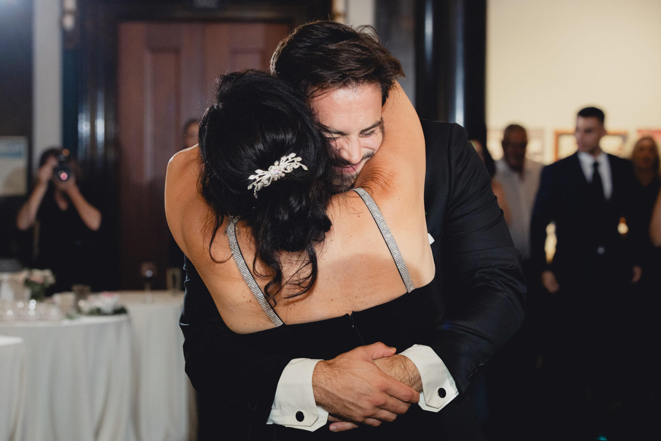 groom dances with mom during wedding reception at the Buffalo History Museum