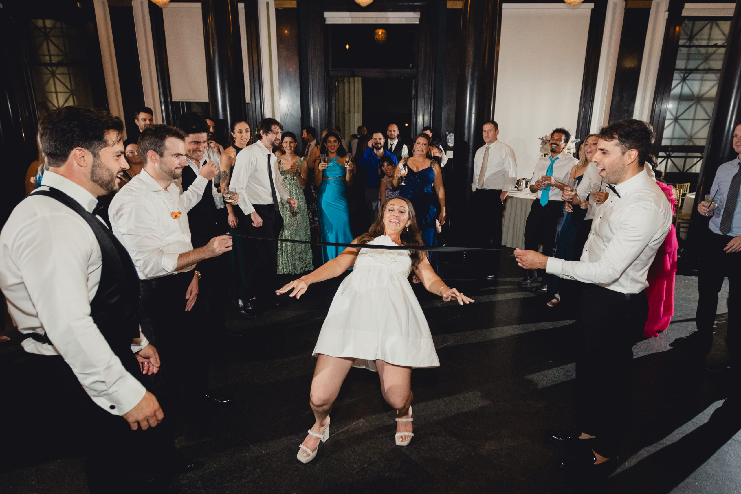 bride limbos during wedding reception at the Buffalo History Museum