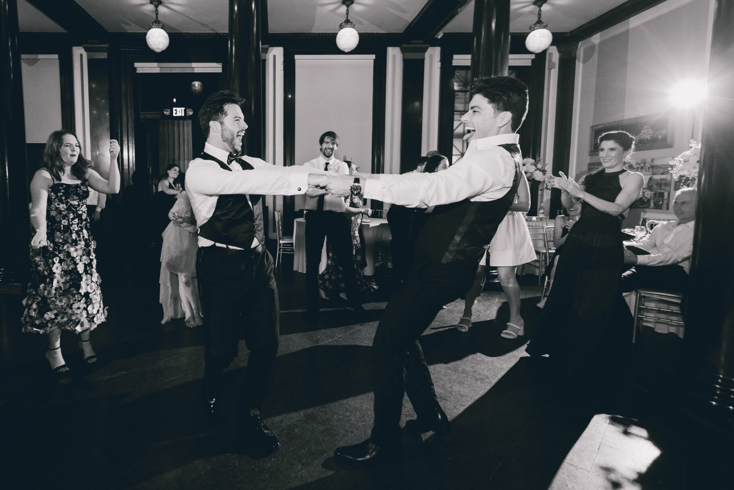 groomsmen spin during wedding reception at the Buffalo History Museum