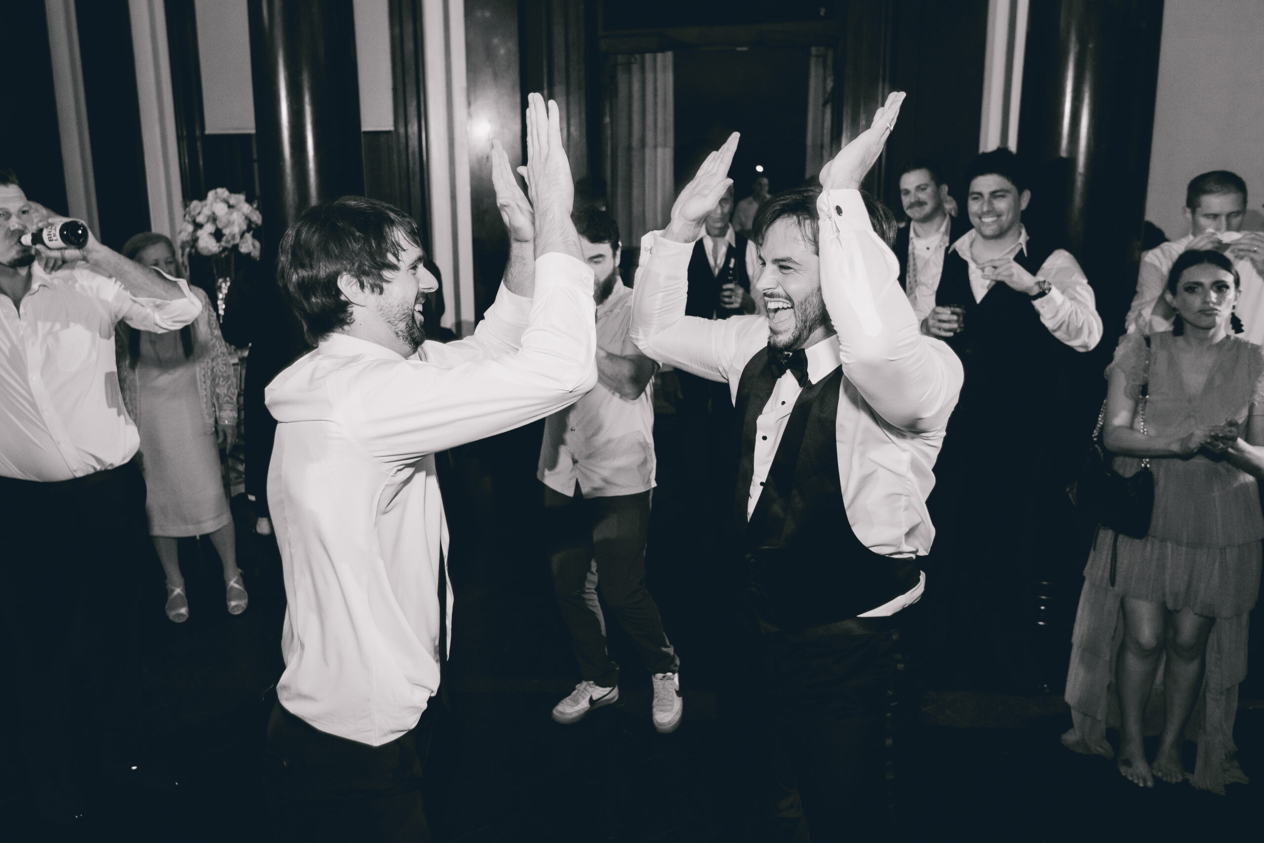 guests high five during wedding reception at the Buffalo History Museum