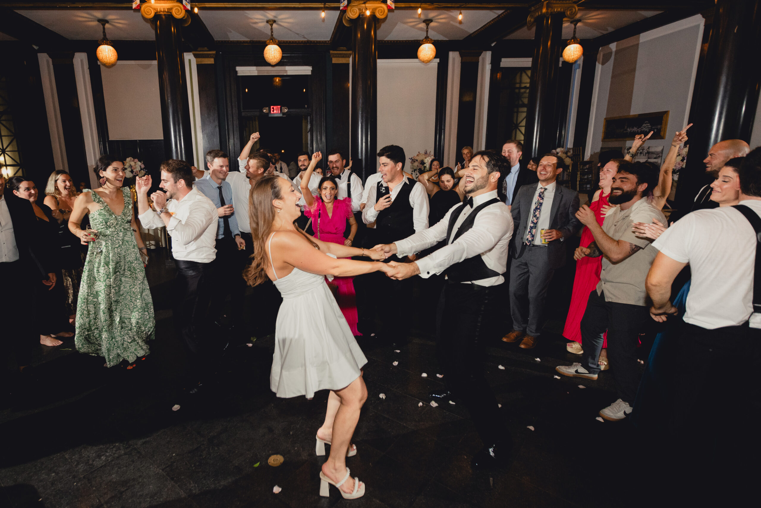 bride and groom spin while holding hands during wedding reception at the Buffalo History Museum