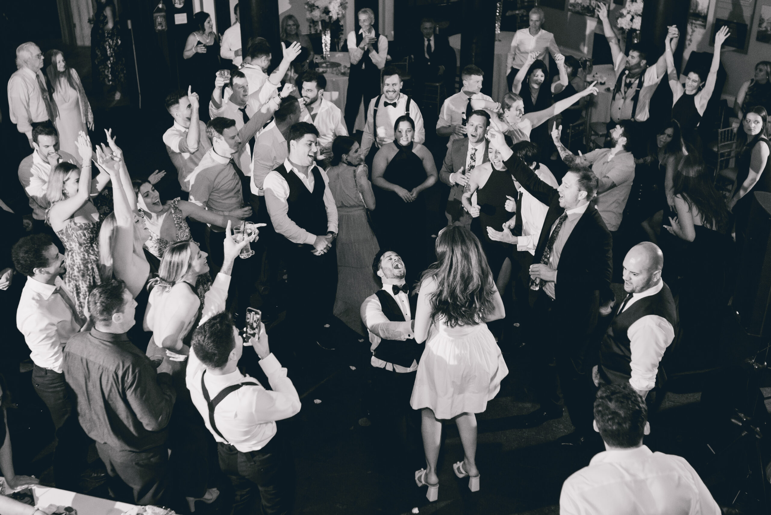 groom sings to bride during wedding reception at the Buffalo History Museum