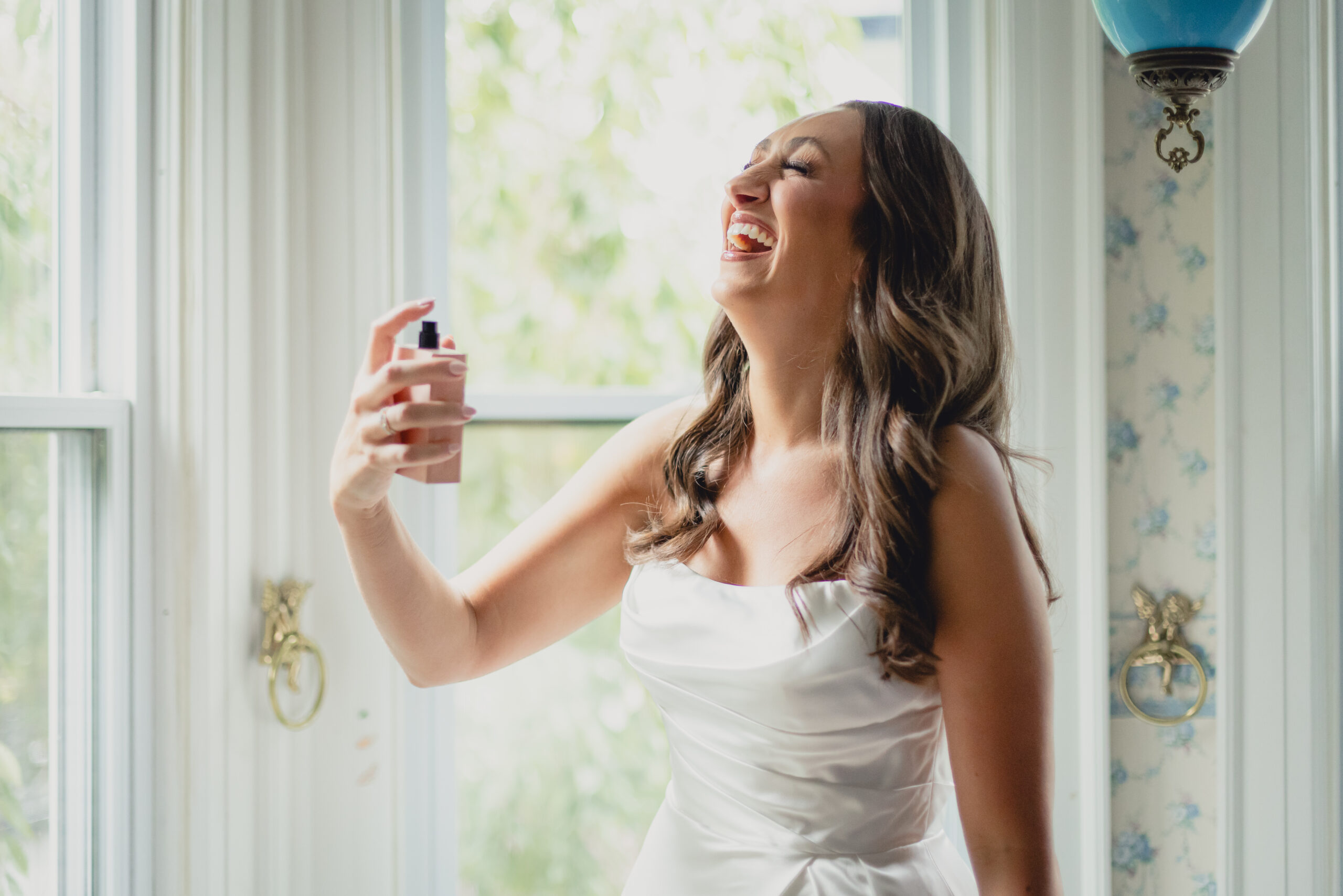 bride sprays perfume in childhood bedroom before wedding in Buffalo, NY