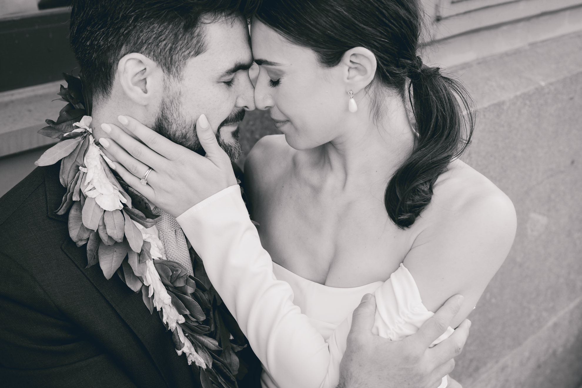 bride and groom pose for portrait in downtown Buffalo, NY after wedding ceremony