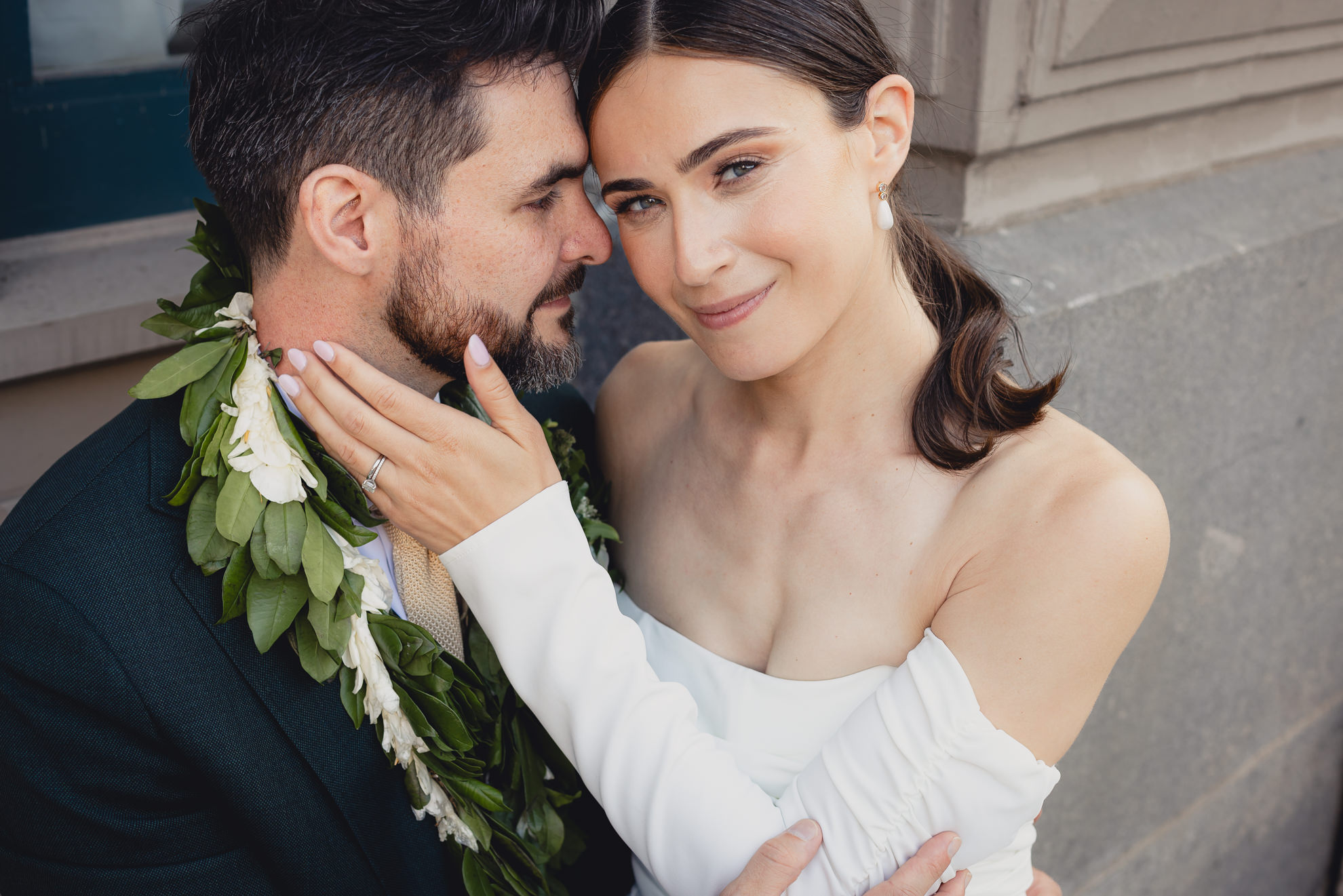 bride and groom pose for portrait in downtown Buffalo, NY after wedding ceremony